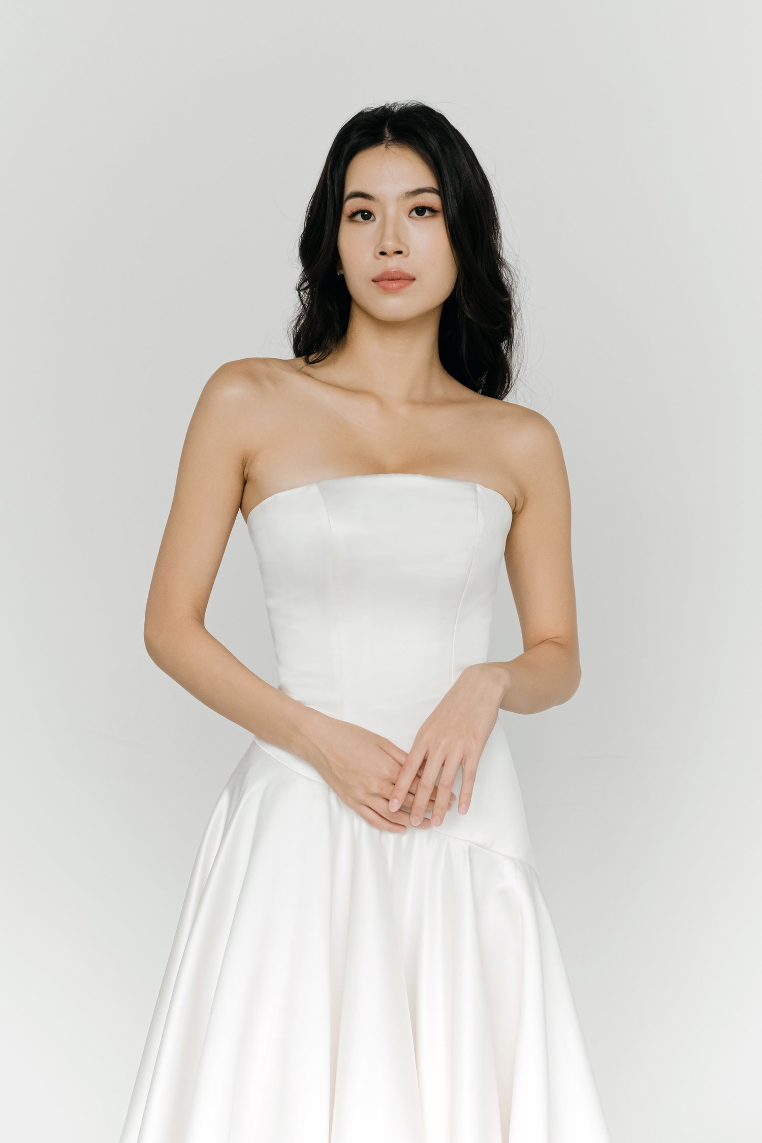 Carmen wedding dress front view with a straight neckline and minimalist silhouette