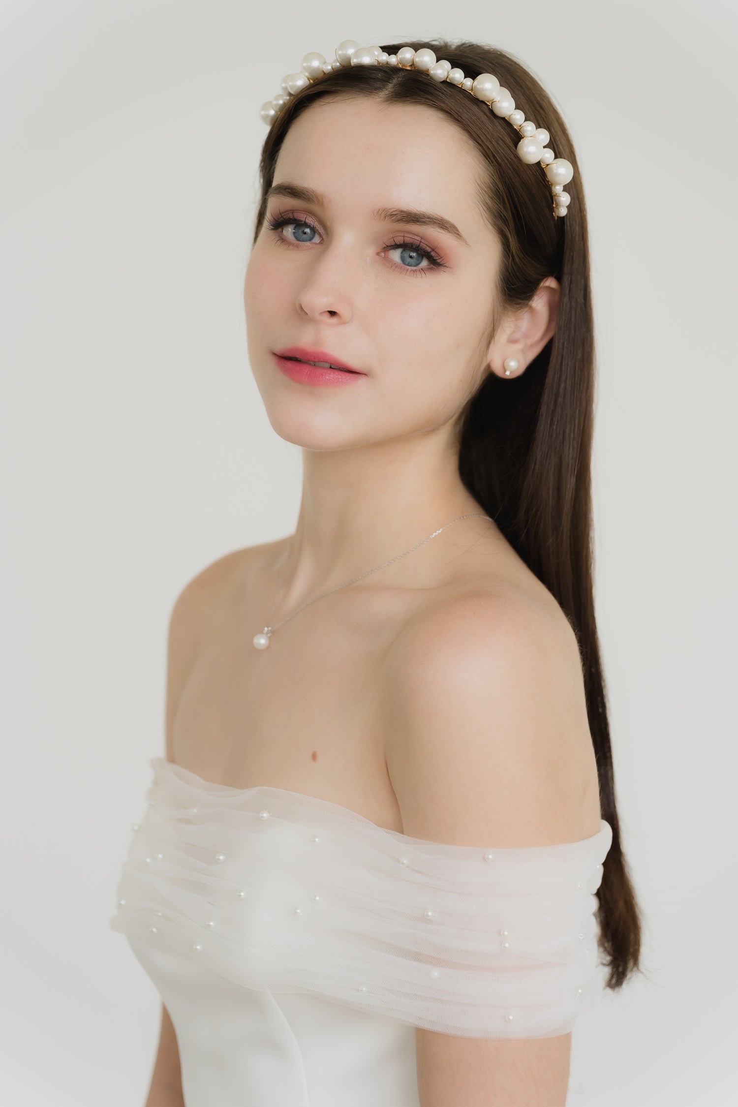 Claire bridal gown featuring the detachable pearl-studded tulle wrap