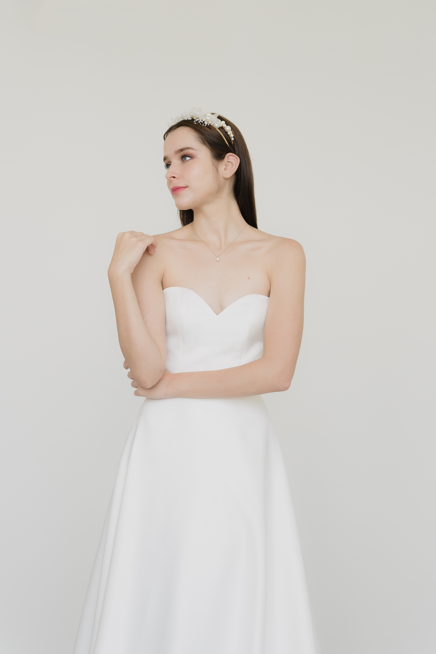 Claire wedding dress front view with a minimalist satin A-line silhouette