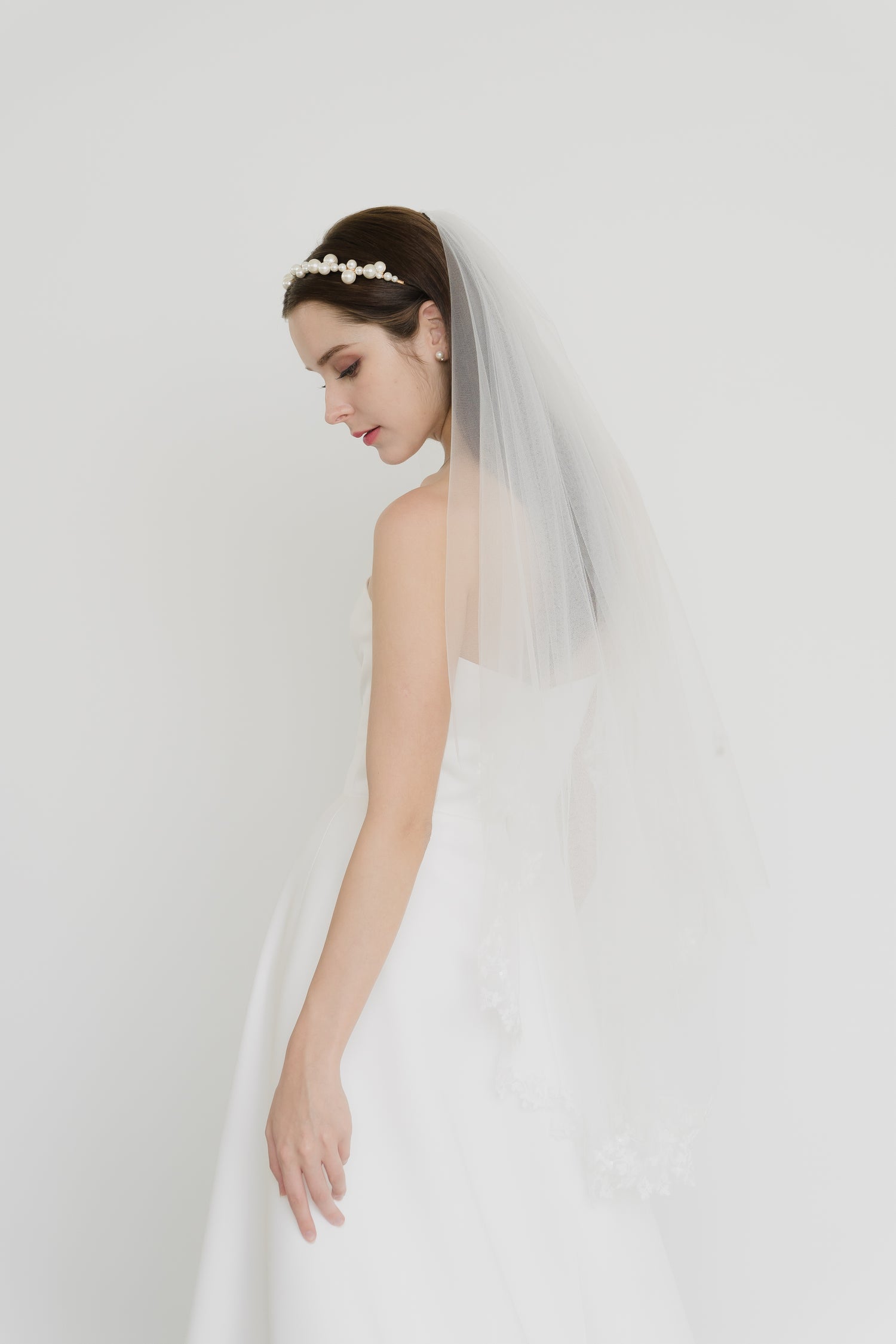 Claire wedding gown side view with a classic satin A-line silhouette