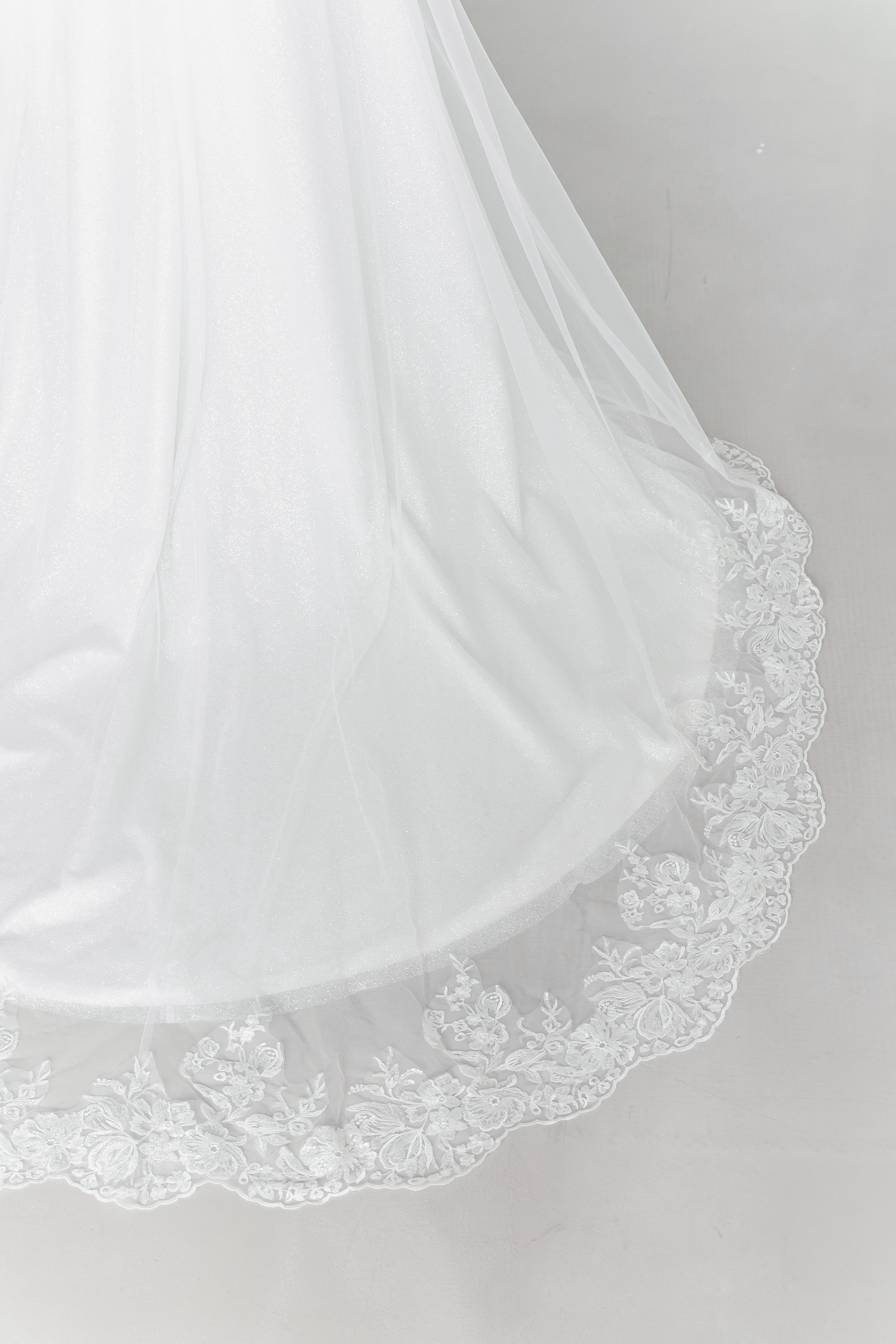 Close-up of Cyra wedding dress with intricate lace appliqués