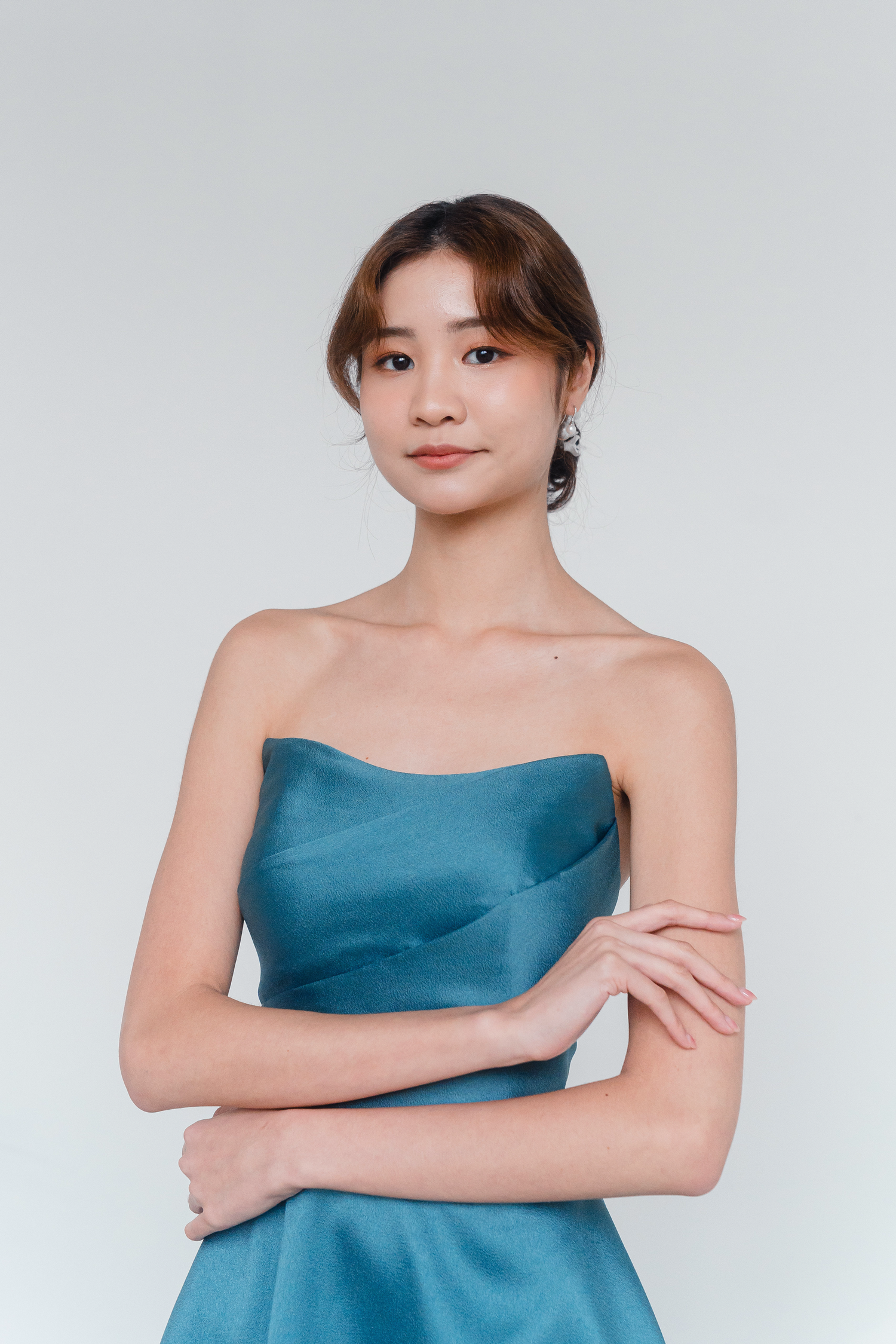 Close-up of Debra evening dress showcasing the soft scoop neckline and pleated bodice