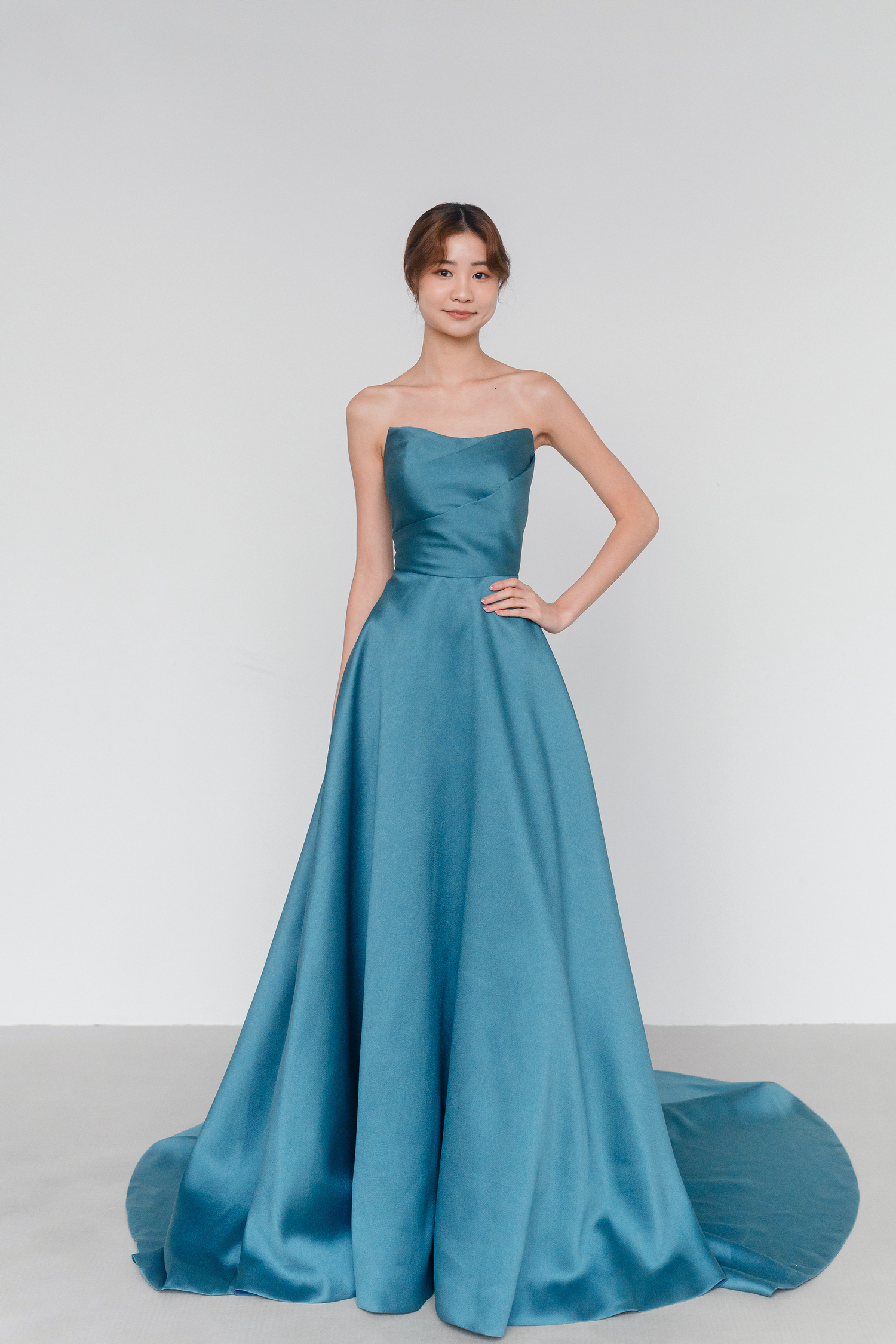 Debra evening dress featuring a rich teal satin A-line silhouette