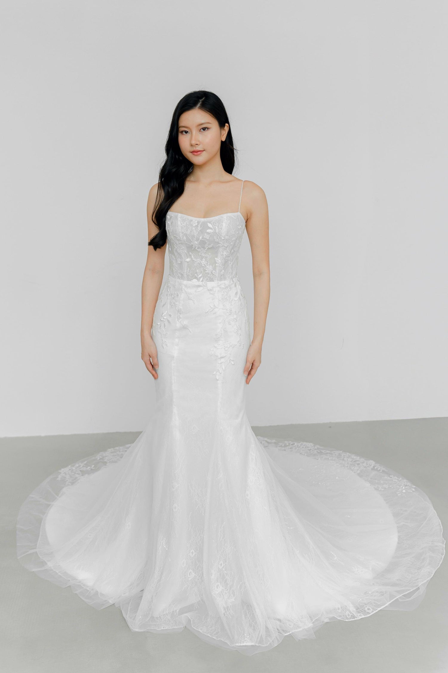 Delfina bridal gown front view with a scoop neckline and delicate lace detailing