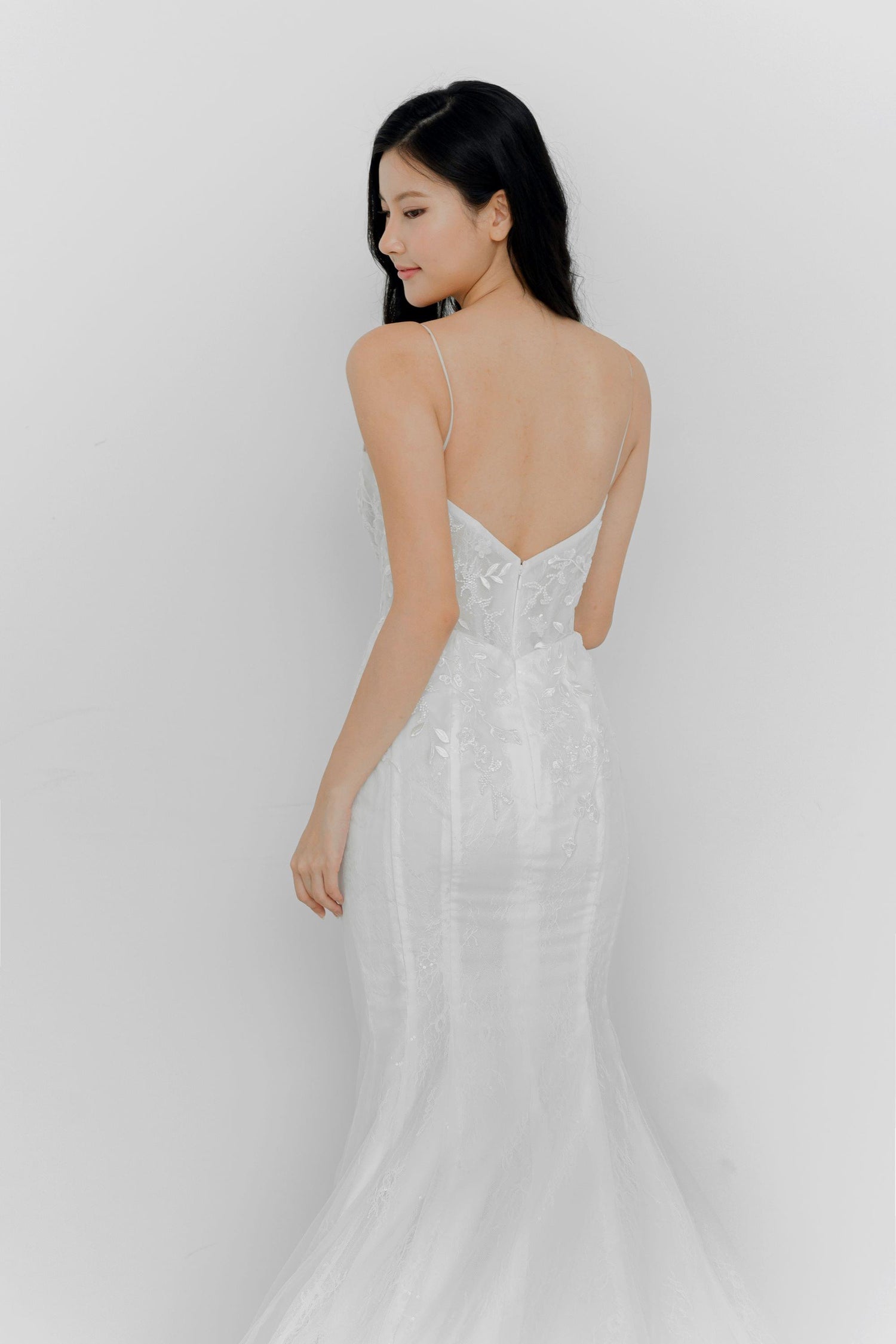 Delfina bridal gown side view showcasing the elegant fitted silhouette