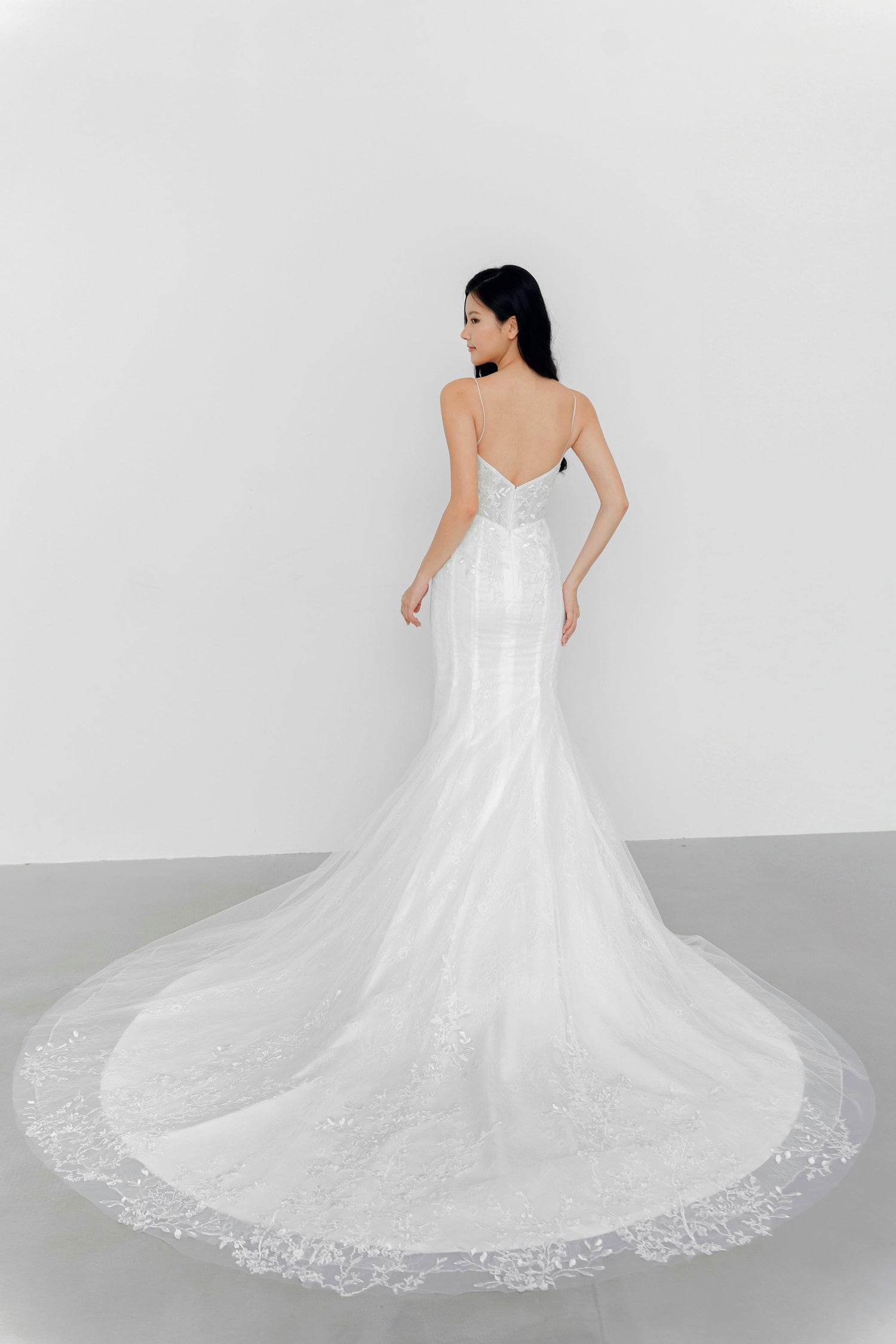 Delfina bridal gown train showcasing the flowing lace layers and soft train