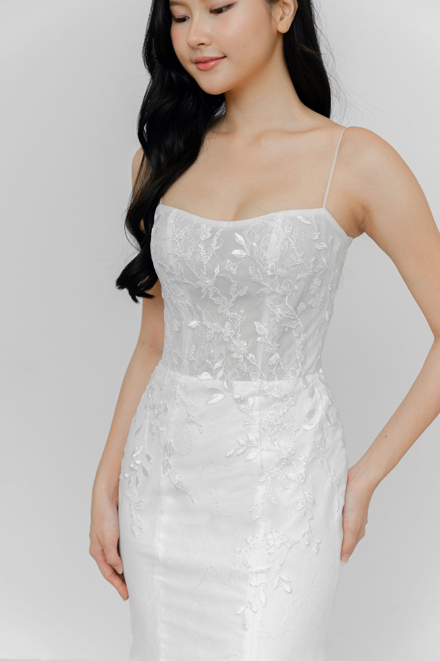Delfina wedding dress featuring a romantic lace silhouette with slender straps