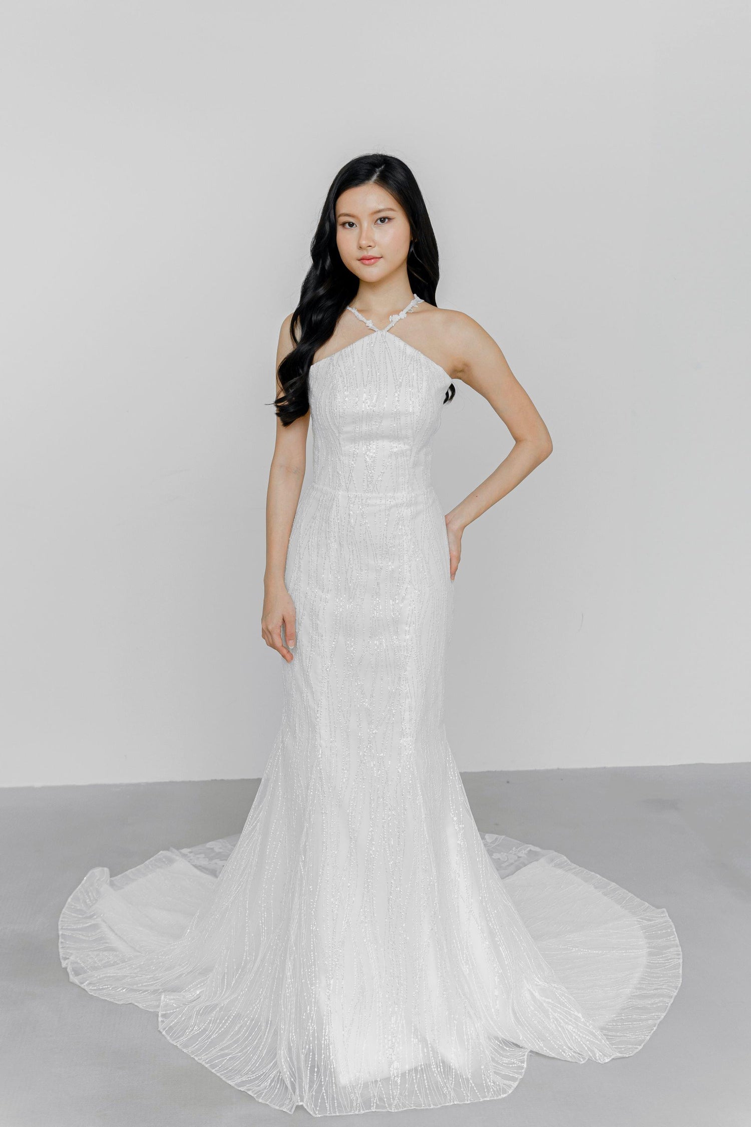 Dinna wedding dress front view with cross halter straps and a shimmering mermaid silhouette