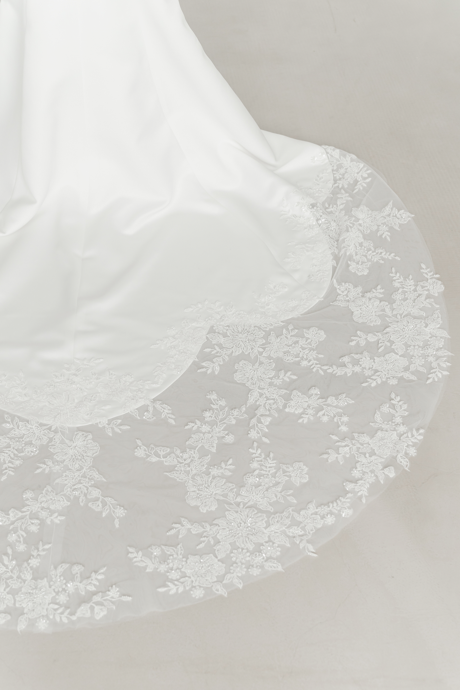 Close-up of Eleanor bridal gown showcasing the lace-edged train
