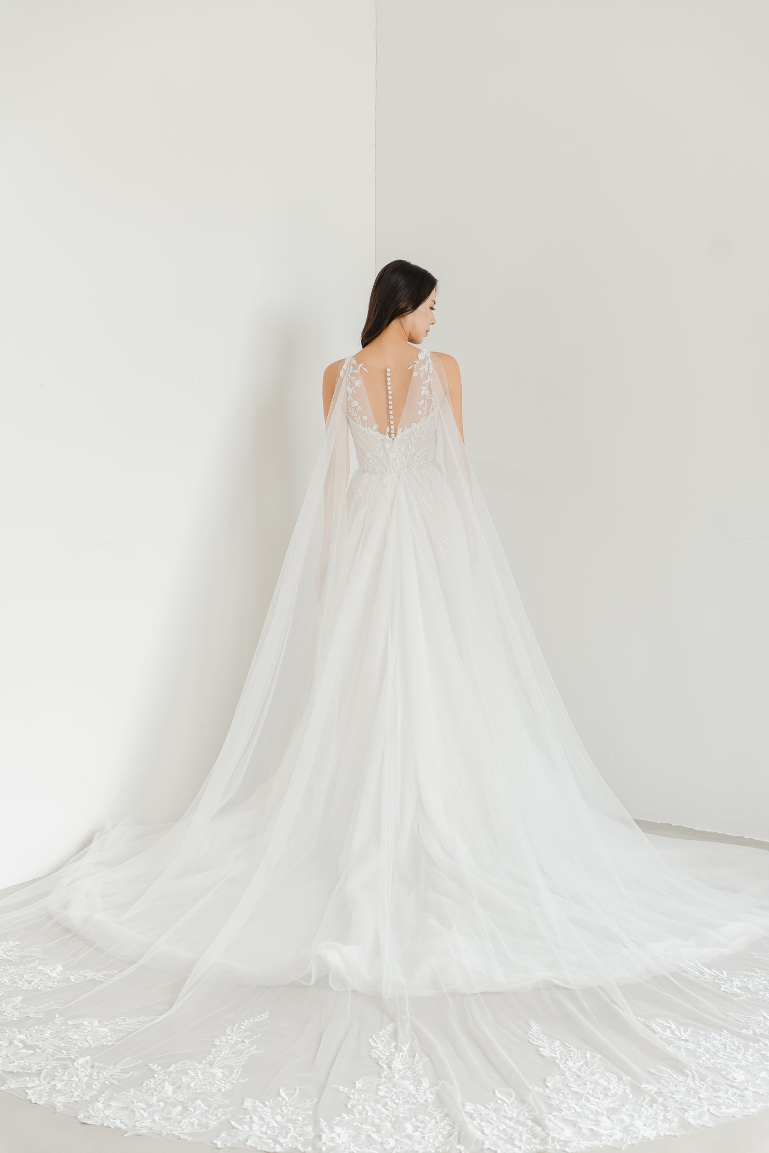 Elisha bridal gown with the detachable lace cape train creating a dramatic bridal entrance