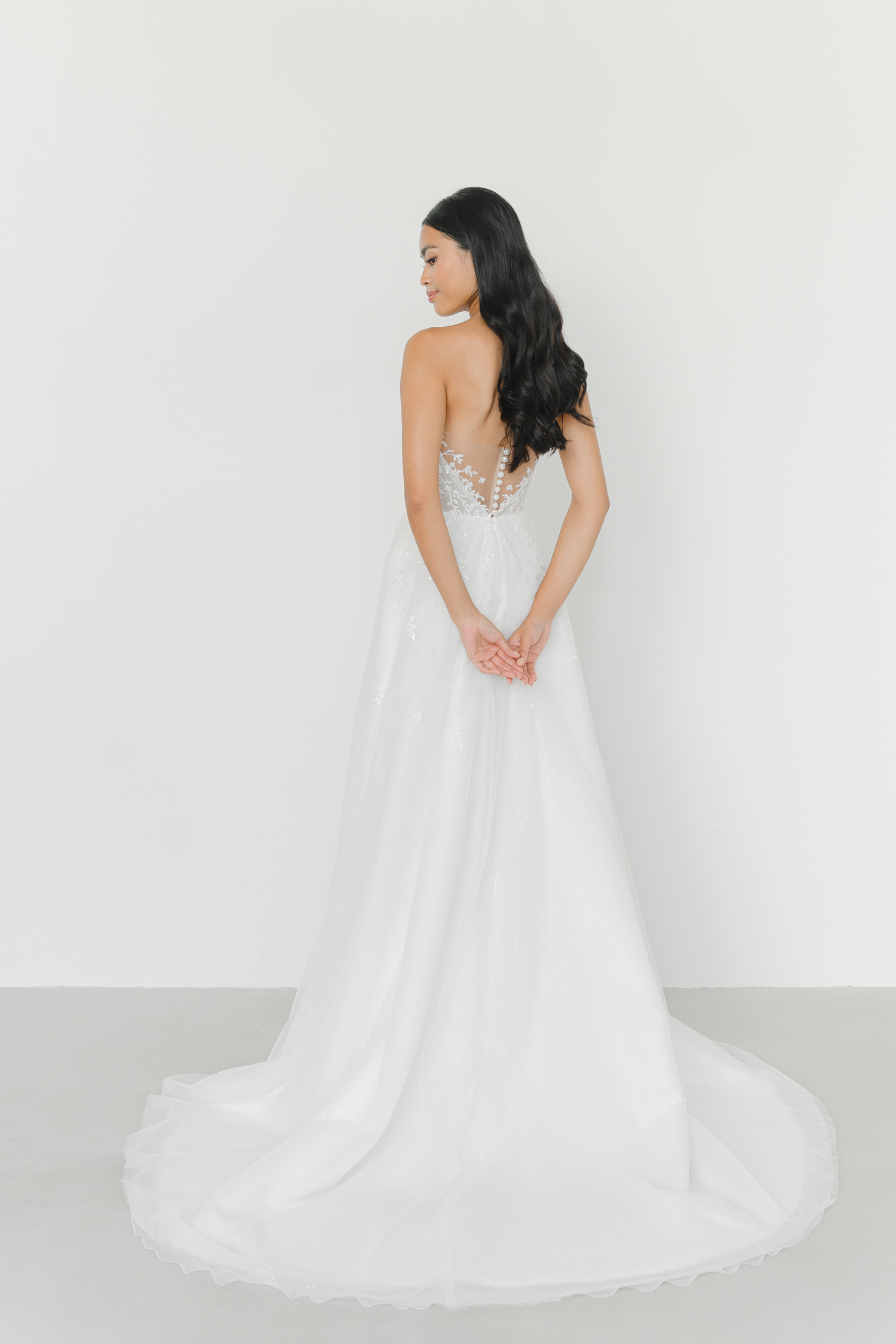Ellery wedding gown train showcasing subtle sparkle and a graceful flowing train