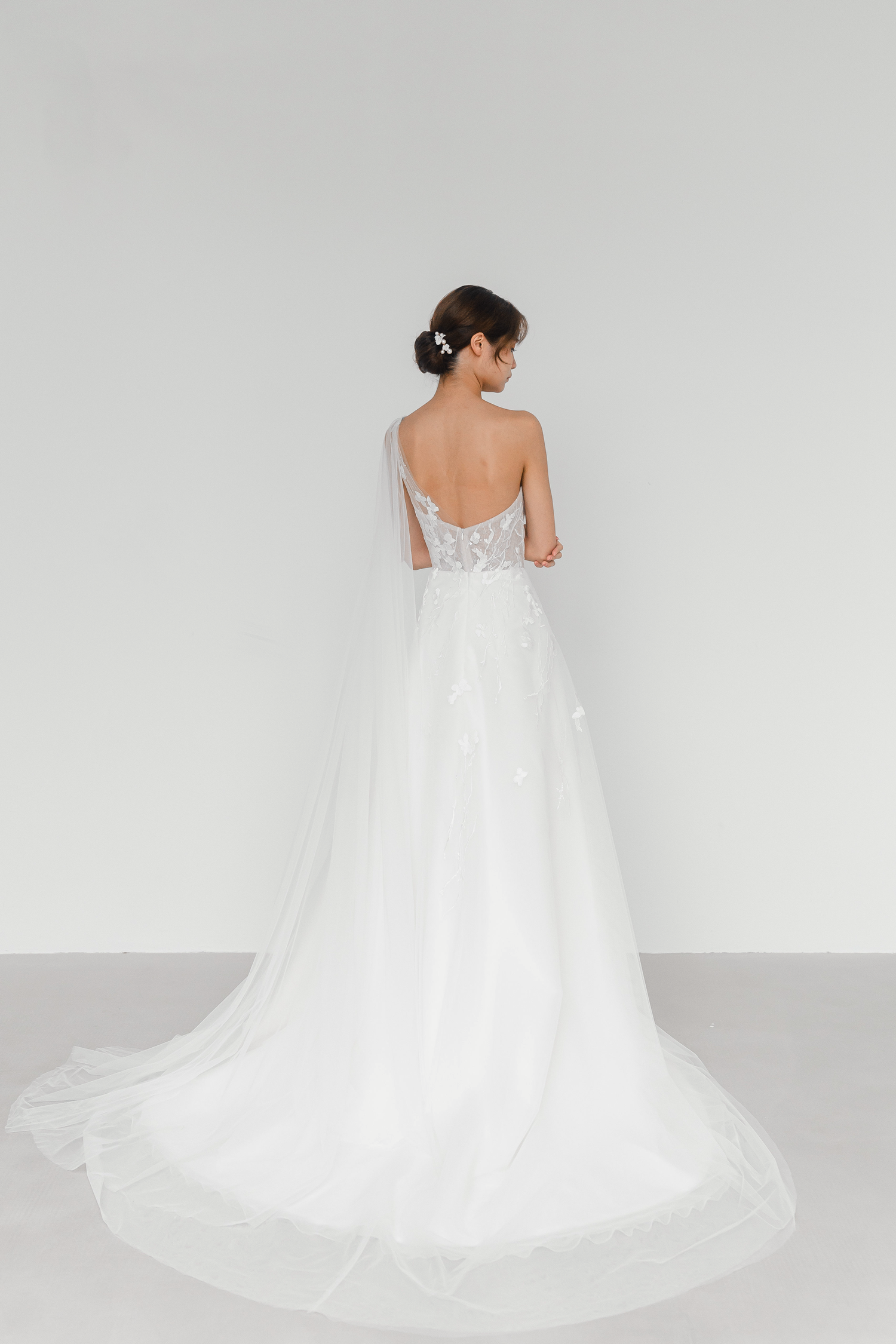 Emelia bridal gown back view with an elegant flowing cape