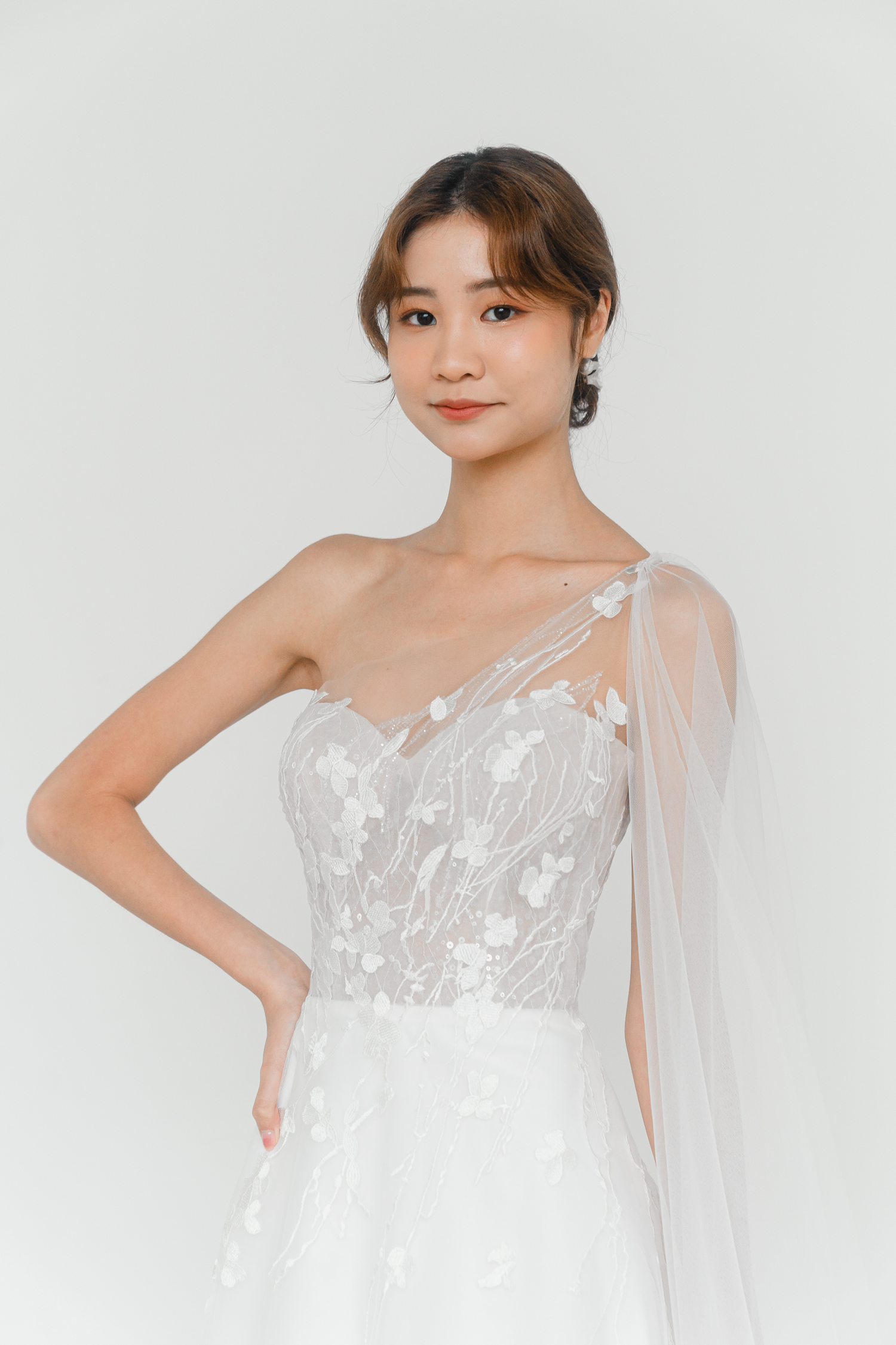 Emelia bridal gown featuring a flowing cape detail and delicate lace