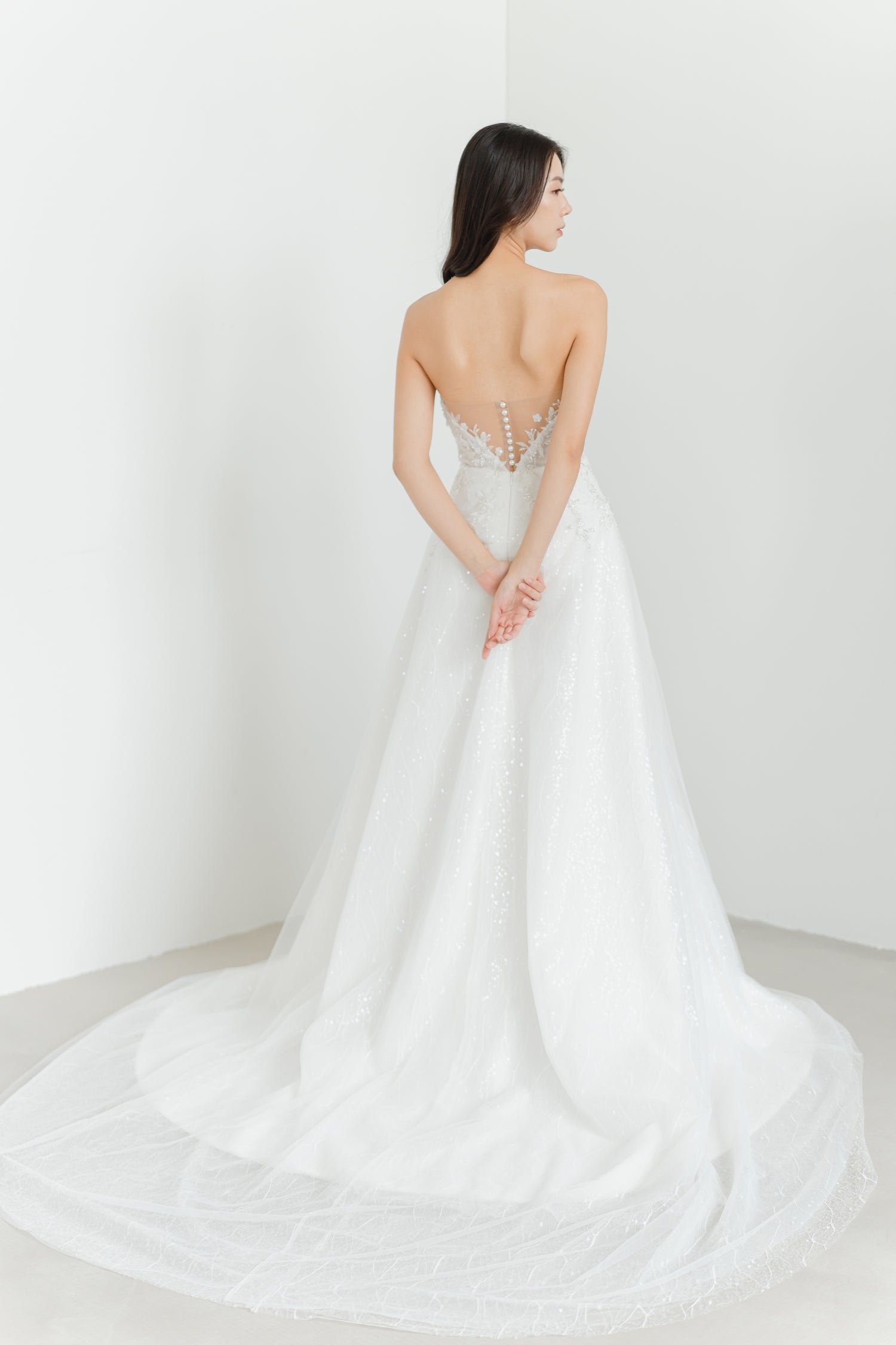 Estee bridal gown back view with an illusion lace low-back design