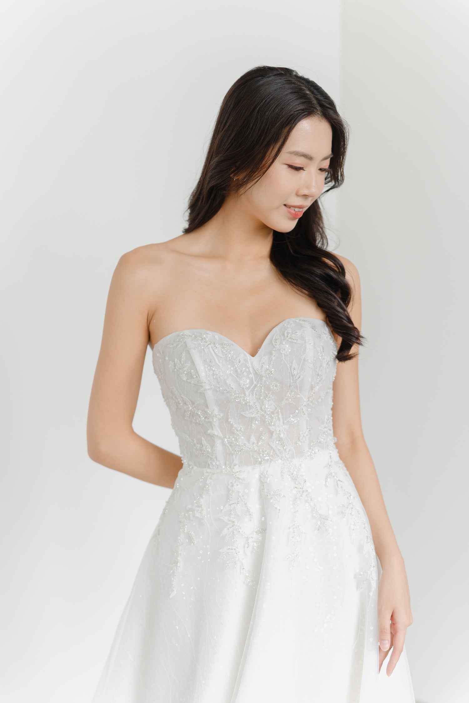 Estee bridal gown featuring beaded leafy motifs over shimmering sequinned fabric