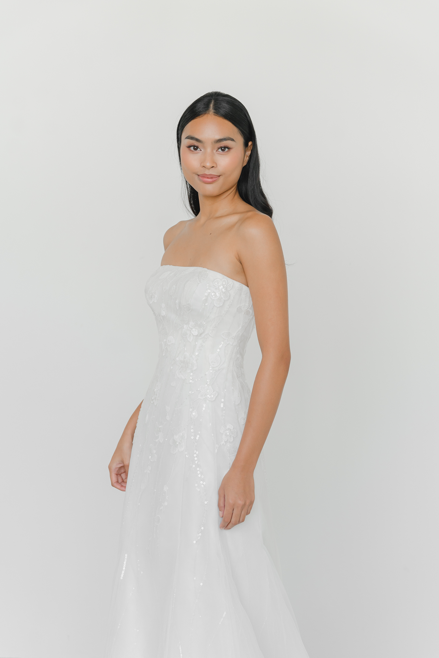 Evan wedding gown side view with a modern slim A-line silhouette