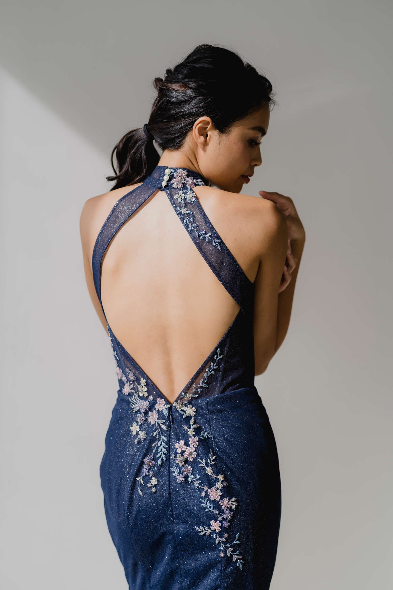 Close-up of Evelyn bridal cheongsam featuring the open diamond back