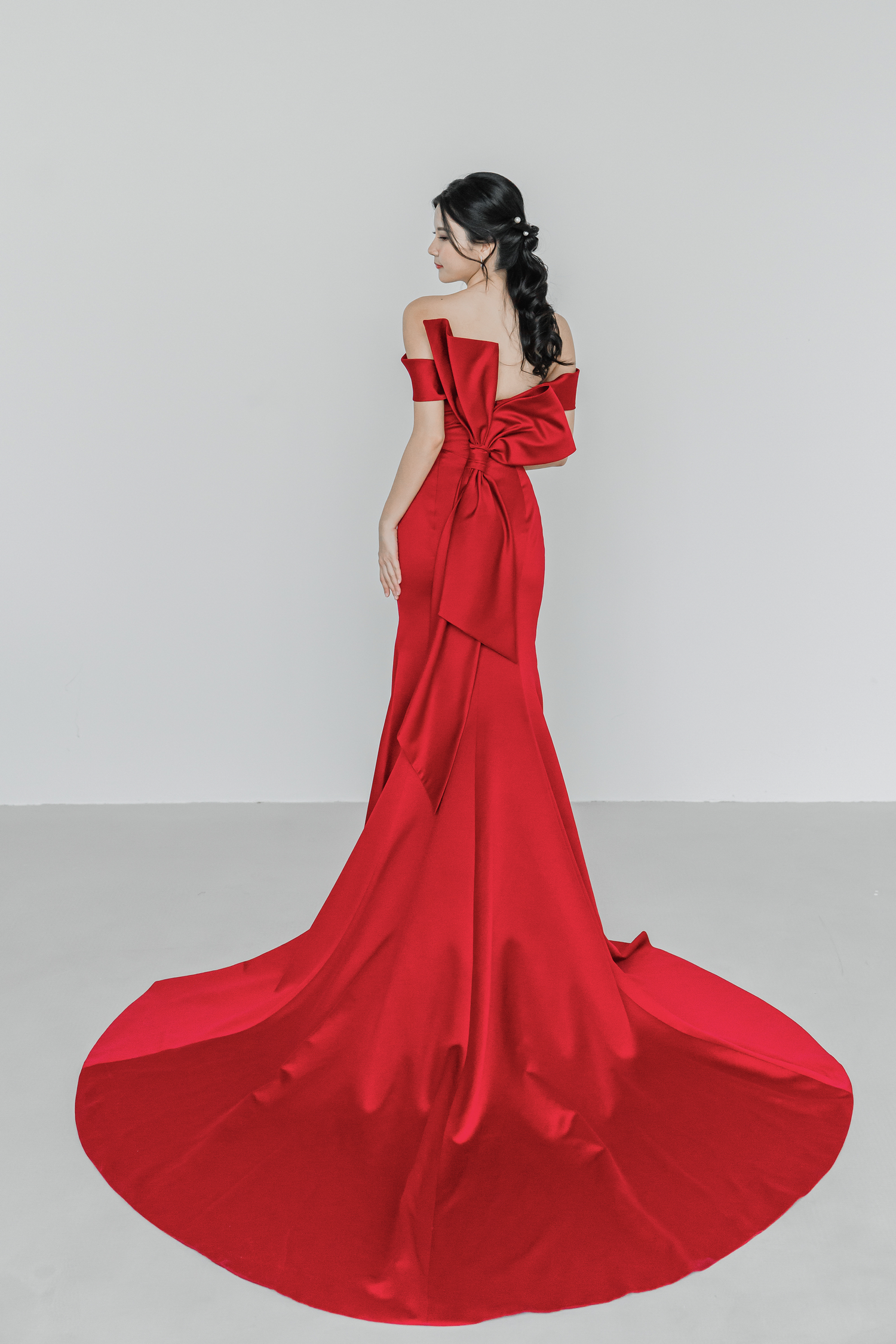 Gizelle evening dress back view with a dramatic origami bow