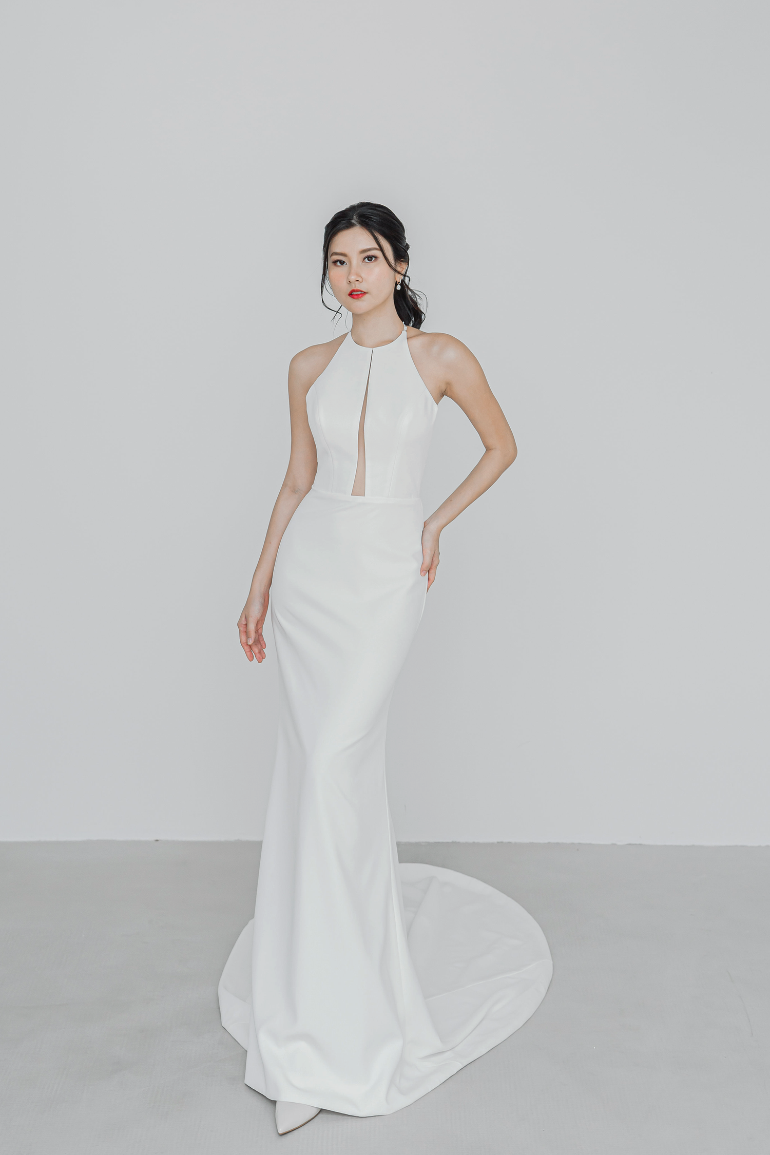 Gloria bridal gown featuring a sleek minimalist silhouette and halter neckline