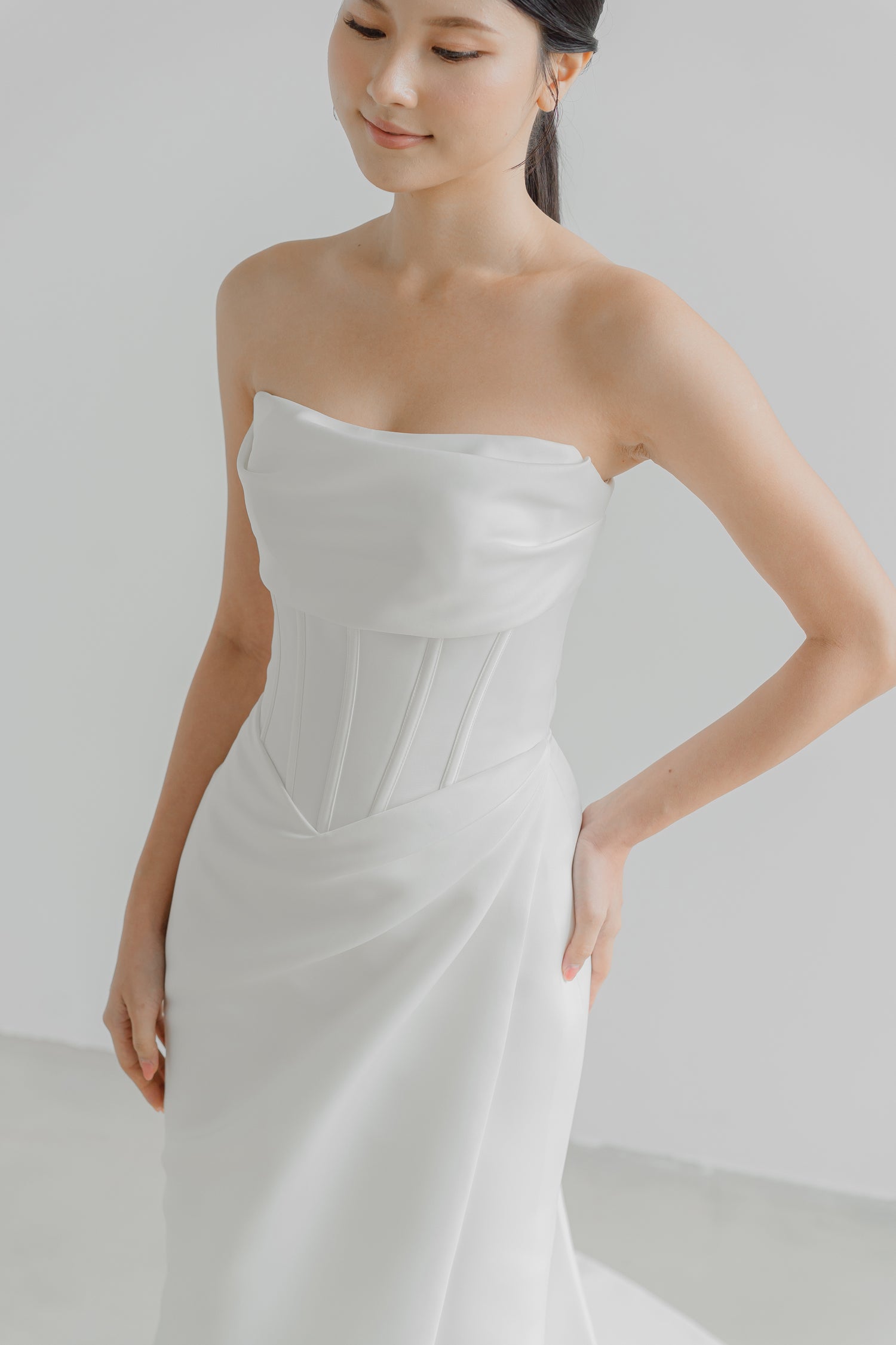 Gracelyn bridal gown featuring a draped cowl front and structured corset bodice