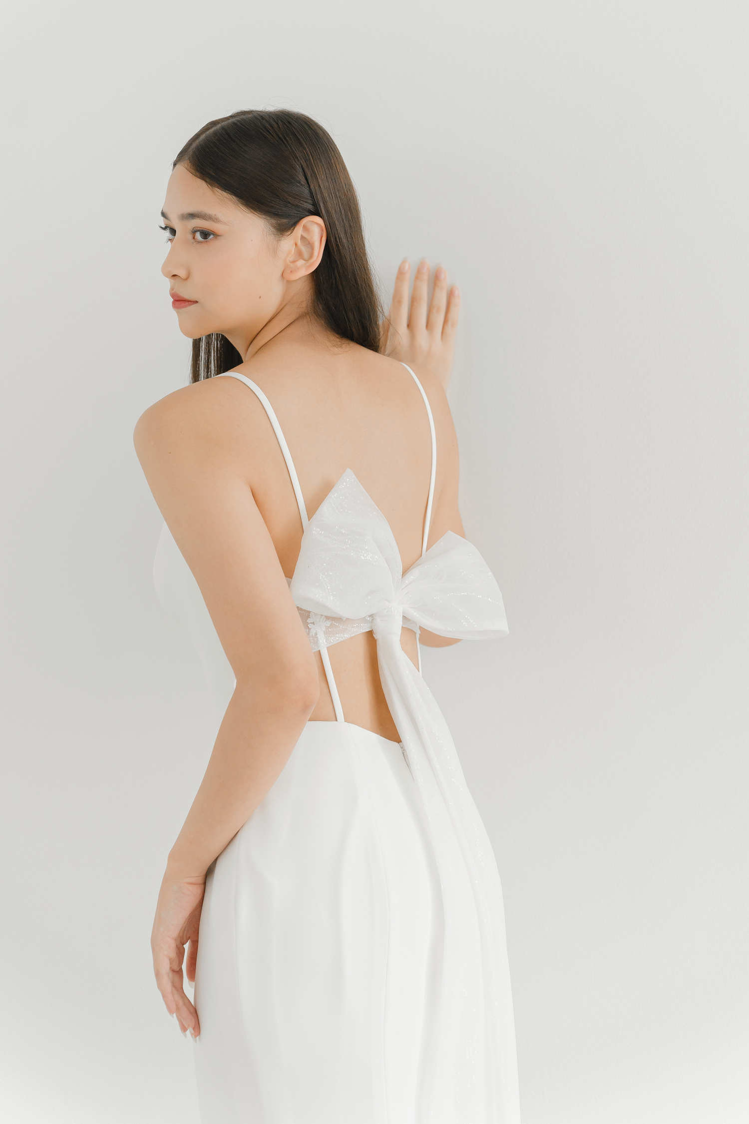 Gwen wedding dress back view with a striking low back and statement bow