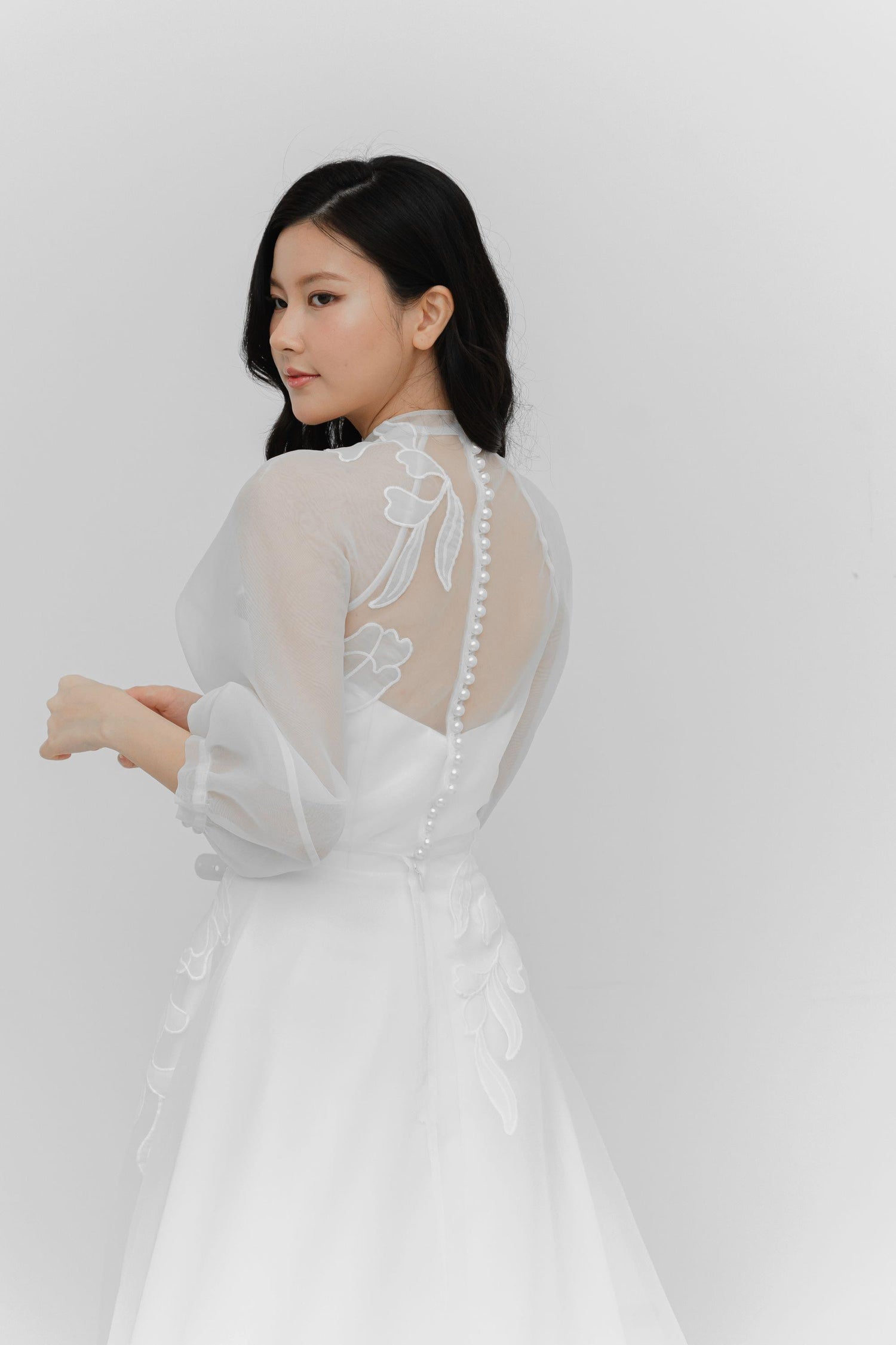 Ivanna bridal gown side view showcasing the organza overlay and elegant silhouette