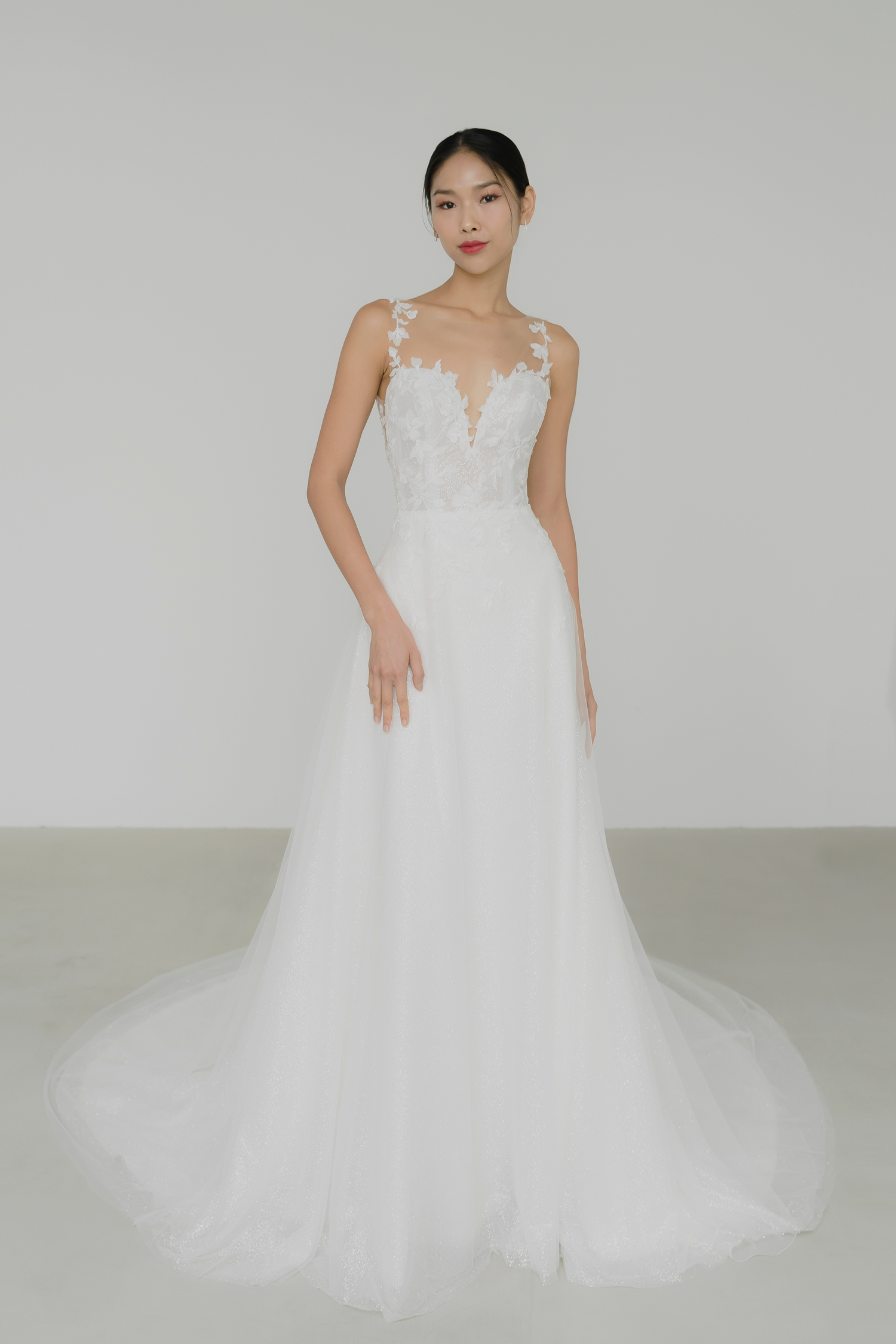 Jenica wedding dress featuring leafy floral appliqués and shimmering glitter tulle
