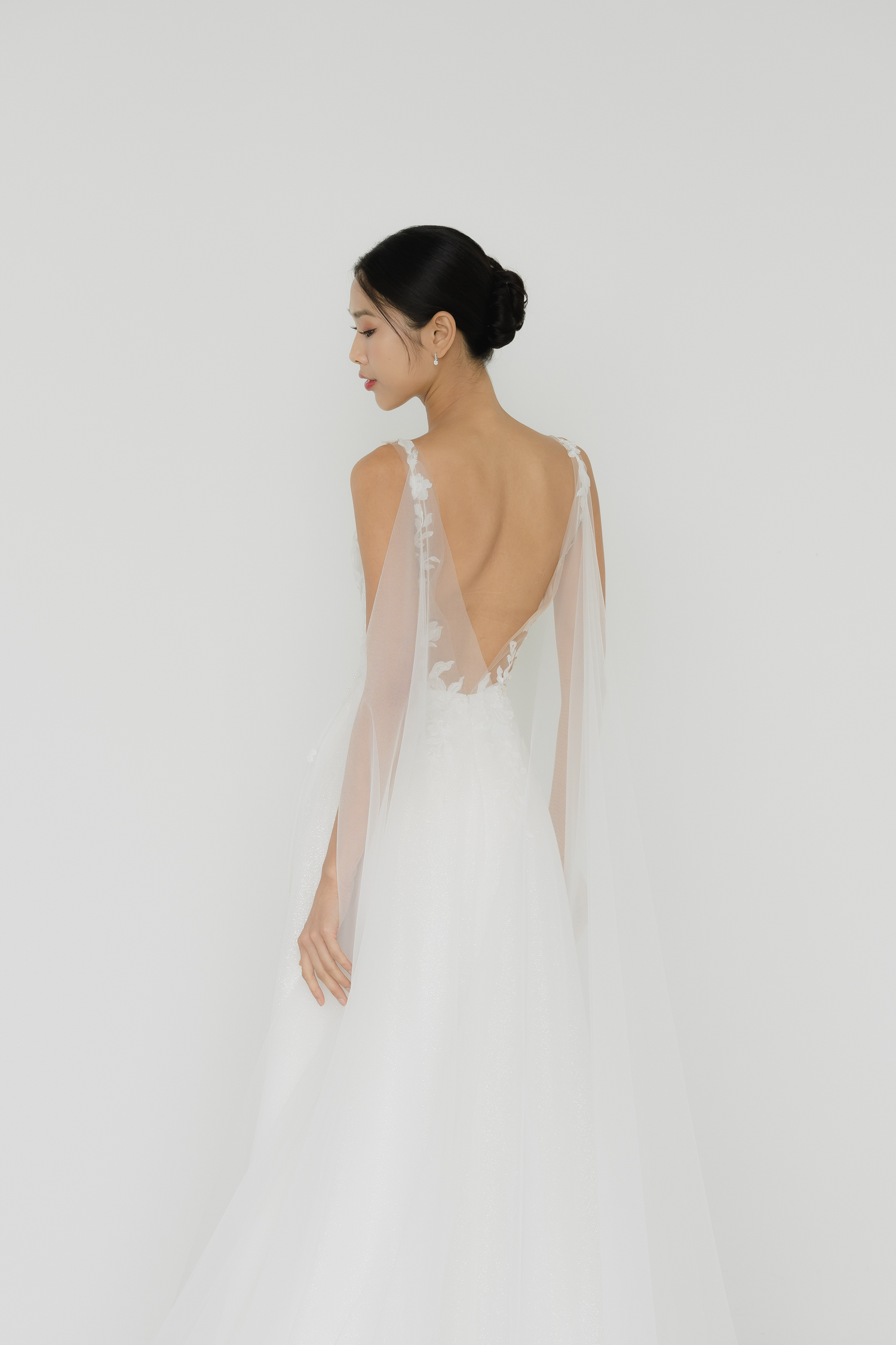 Close-up of Jenica wedding gown highlighting the detachable lace cape train