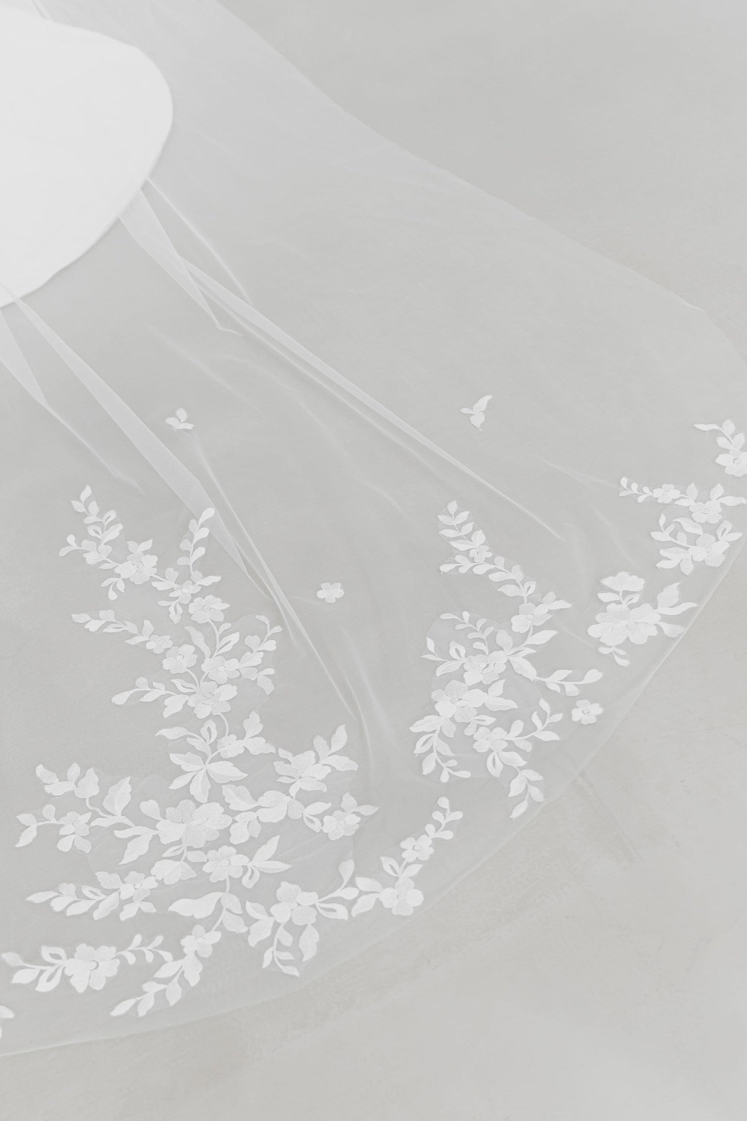 Close-up of Jenna wedding gown highlighting the detachable lace tulle train