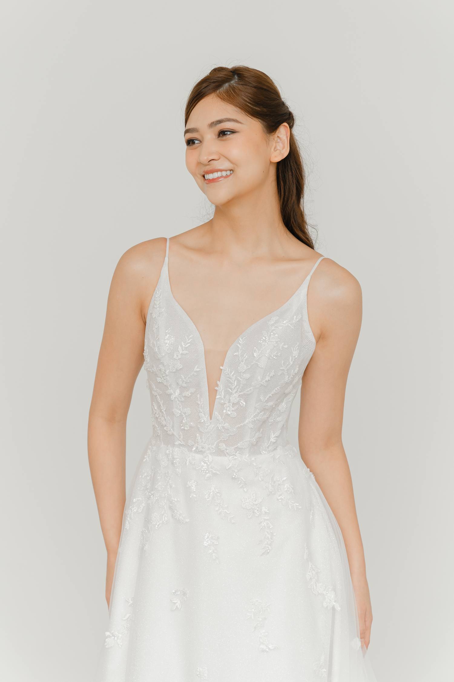 Jorinne bridal gown featuring a deep V-plunge neckline and delicate spaghetti straps