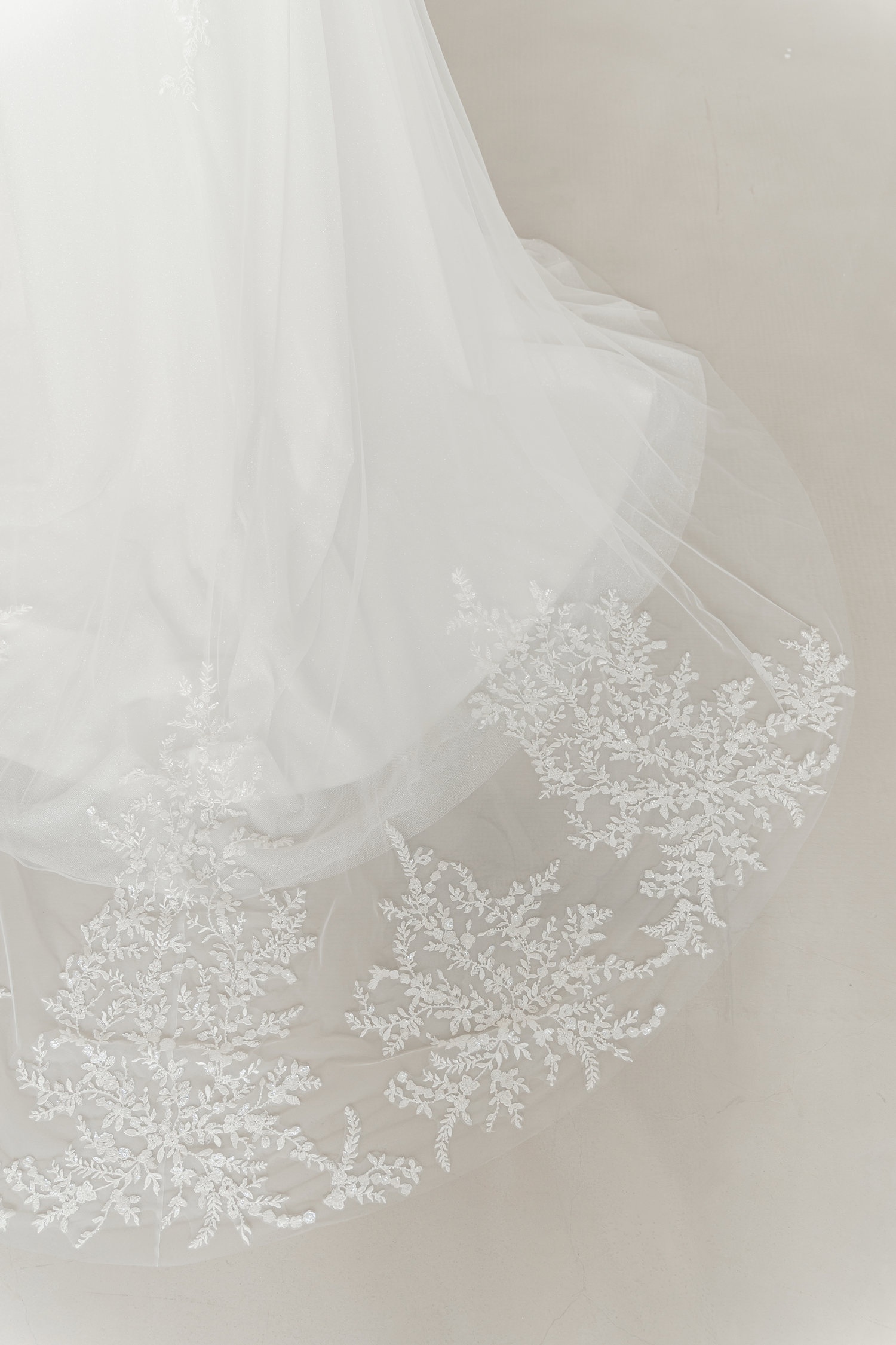 Close-up of Jorinne wedding gown with sparkling beaded lace detailing