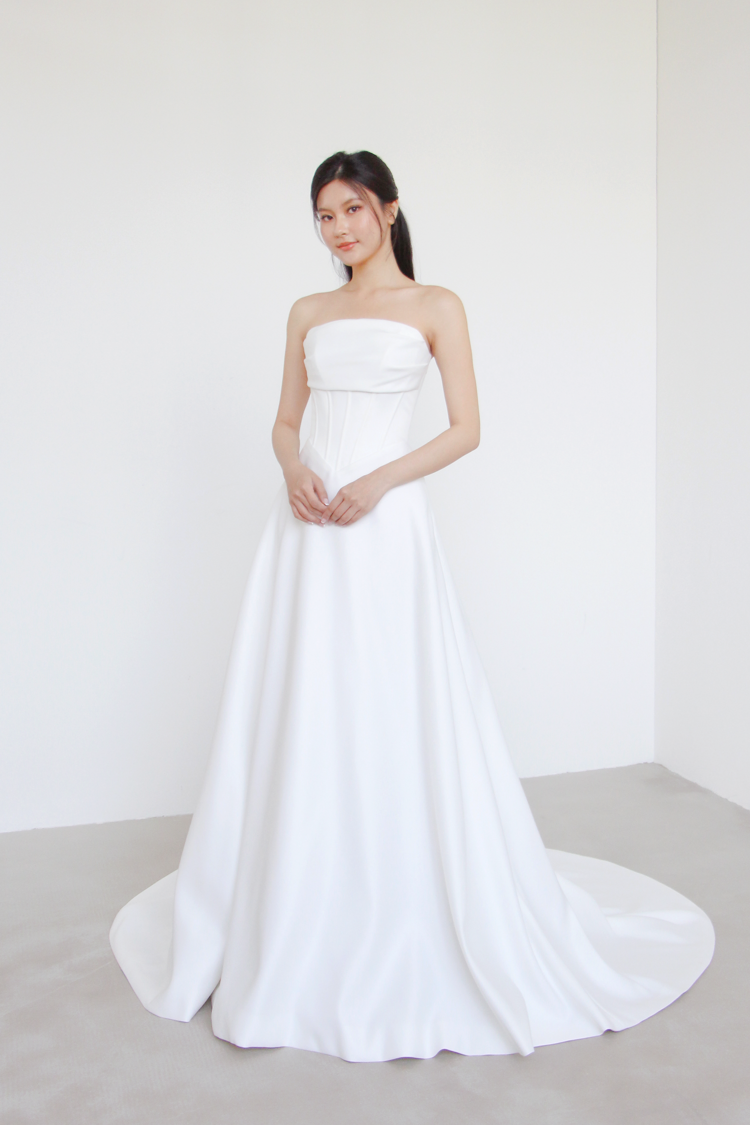 Julee minimalist wedding dress featuring a sculpted V-waist