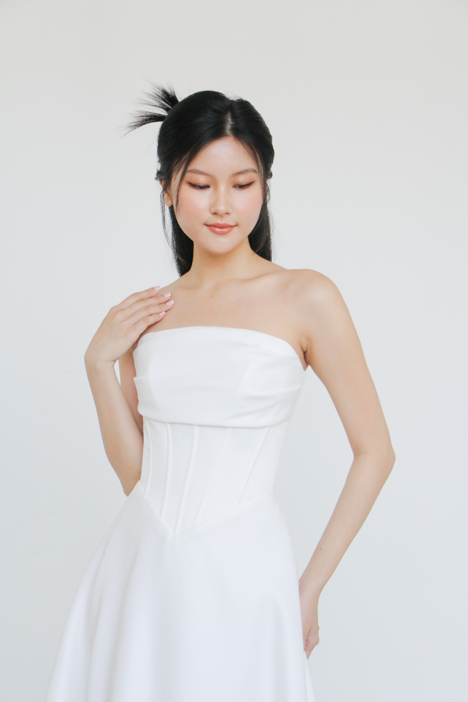Julee wedding dress front view with clean structured bodice and sculpted V-waist
