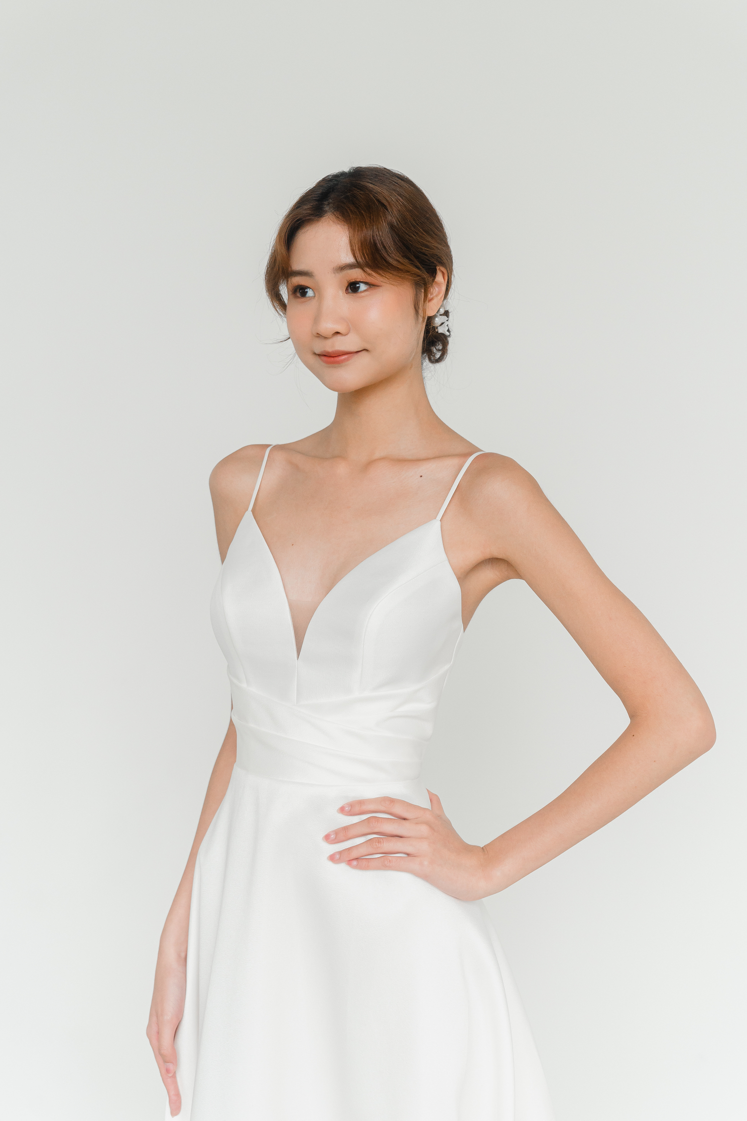 Julia bridal gown featuring a satin crepe silhouette with pleated bodice detailing