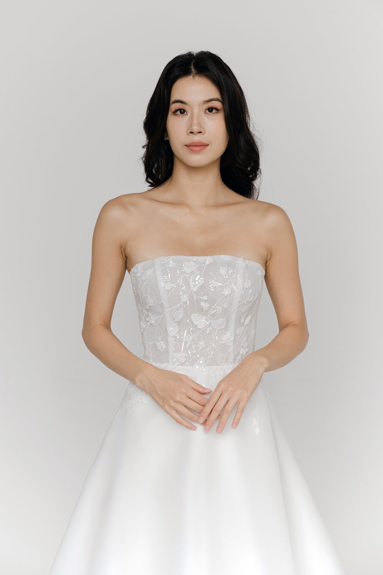Karla bridal gown front view with a lace bodice and flowing organza skirt