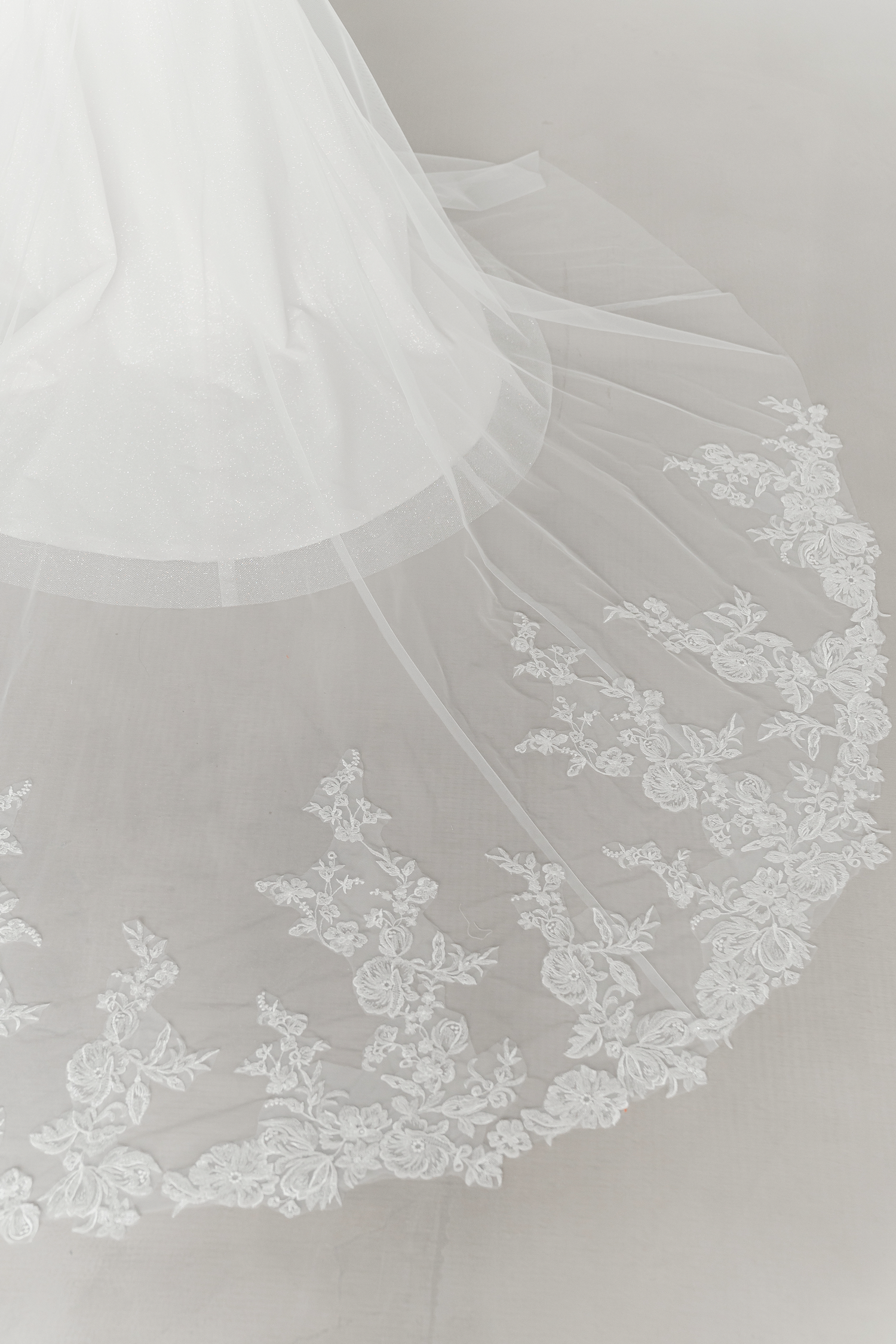 Close-up of Kinsley bridal gown highlighting the shimmering lace embroidery