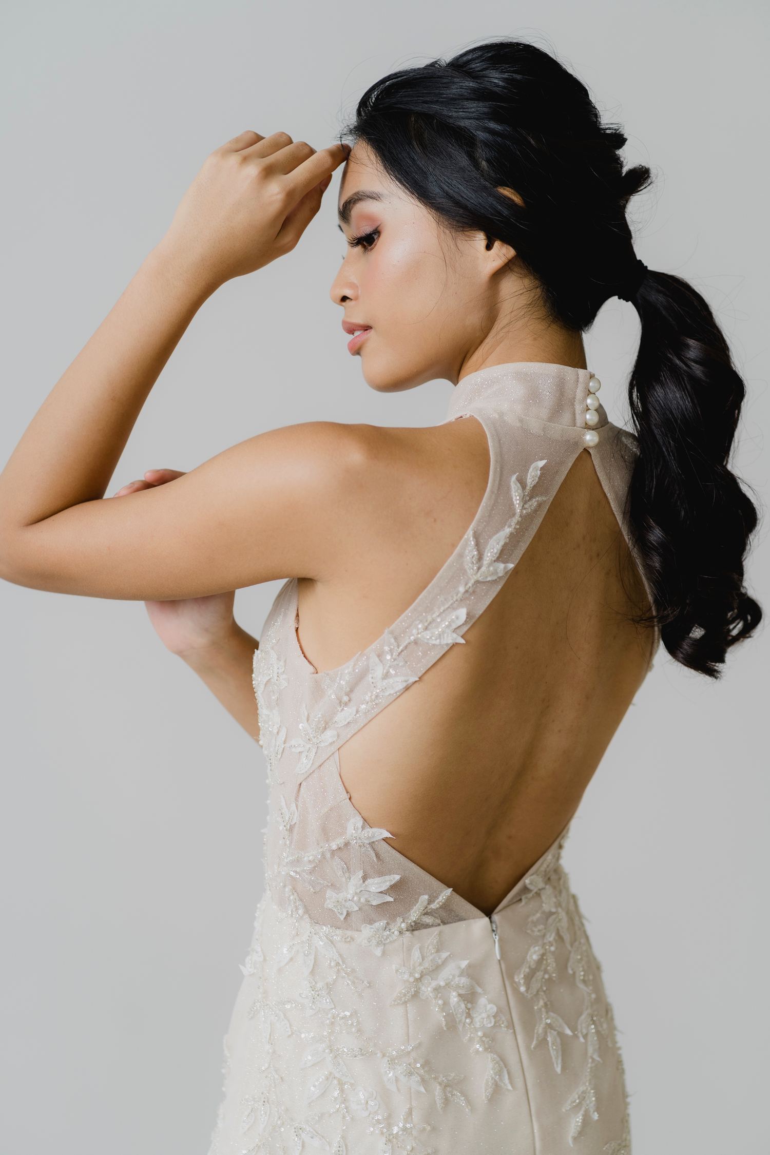 Kristine bridal cheongsam featuring leafy beadwork and an illusion front opening