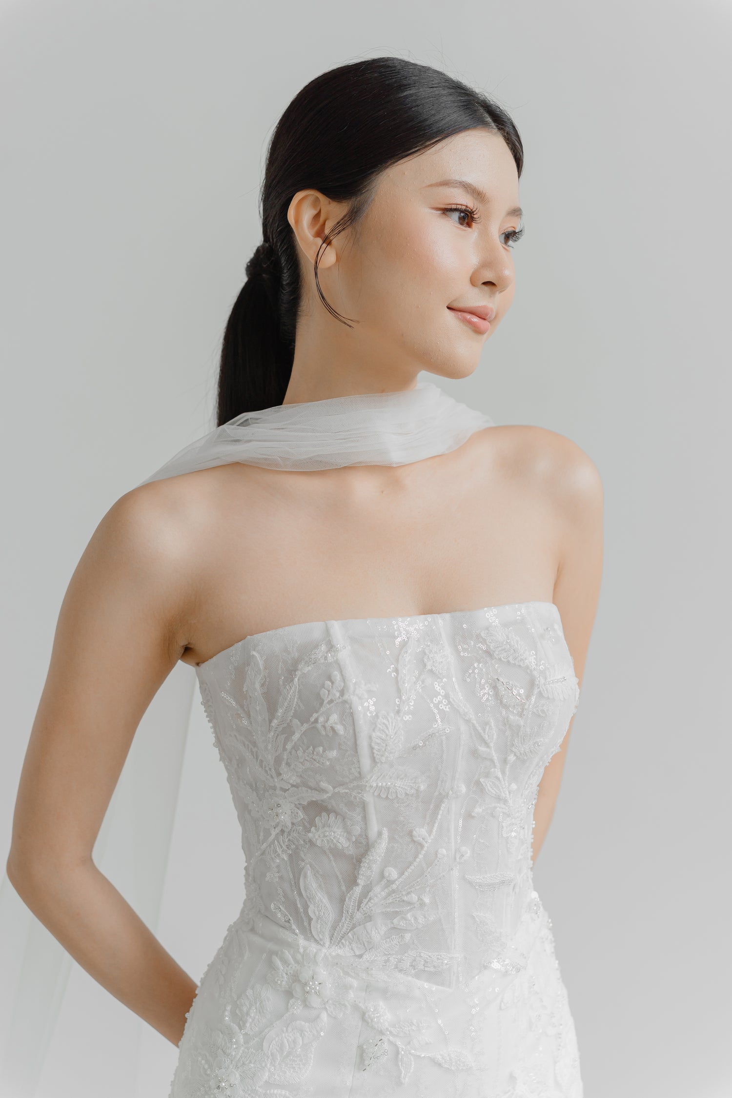 Close-up of Kylie wedding gown highlighting the modern straight neckline