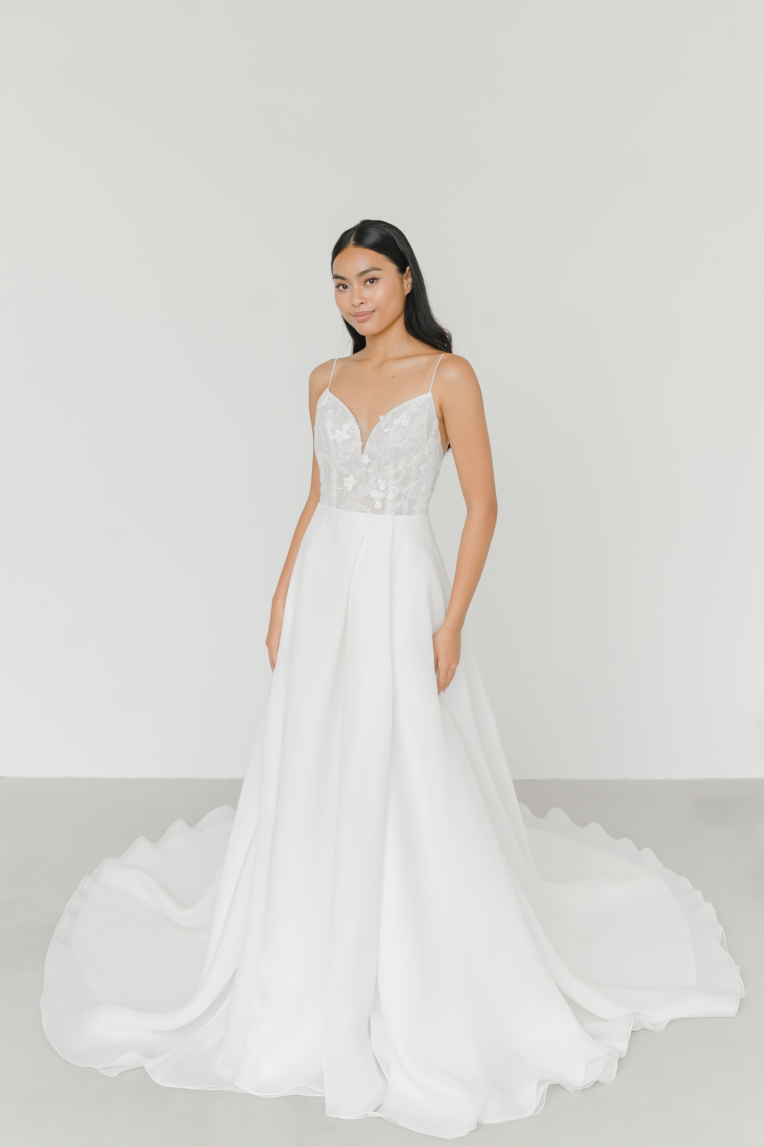 Layla bridal gown featuring delicate spaghetti straps and a flowing organza skirt
