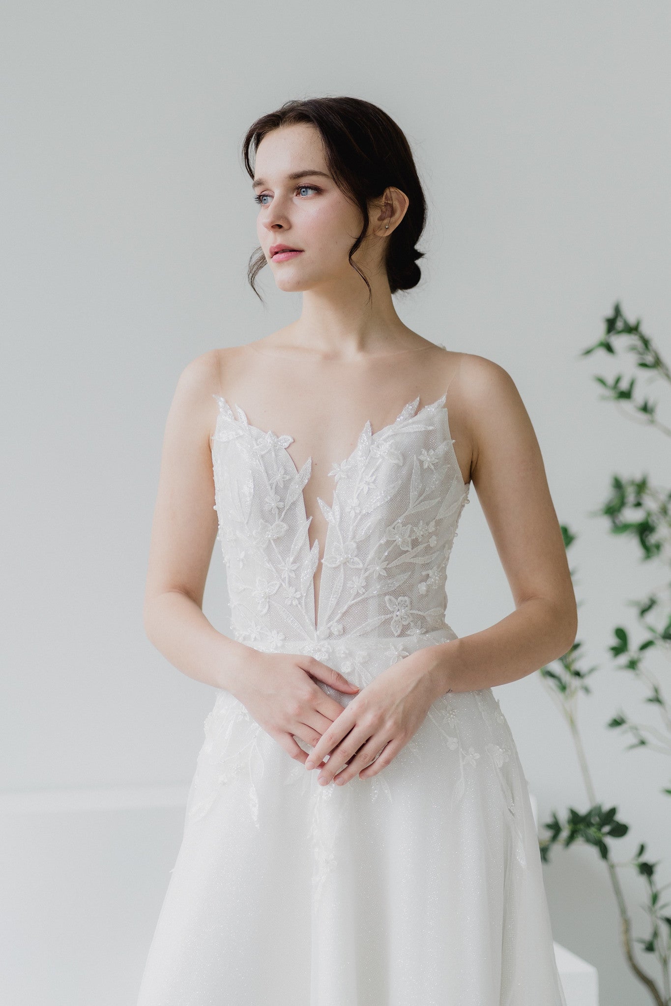 Close-up of Leanne bridal gown with leafy lace appliqué and illusion neckline
