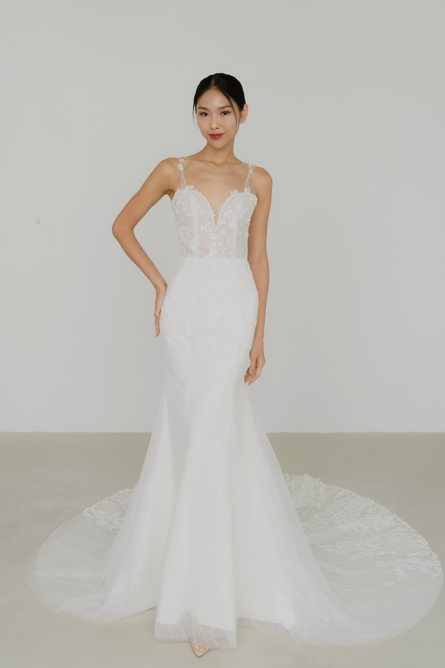 Leia bridal gown front view with a subtle sparkling mermaid silhouette and illusion neckline