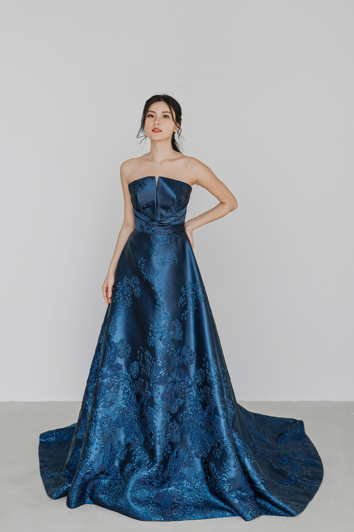Leona evening dress featuring luxurious blue jacquard fabric and an A-line silhouette