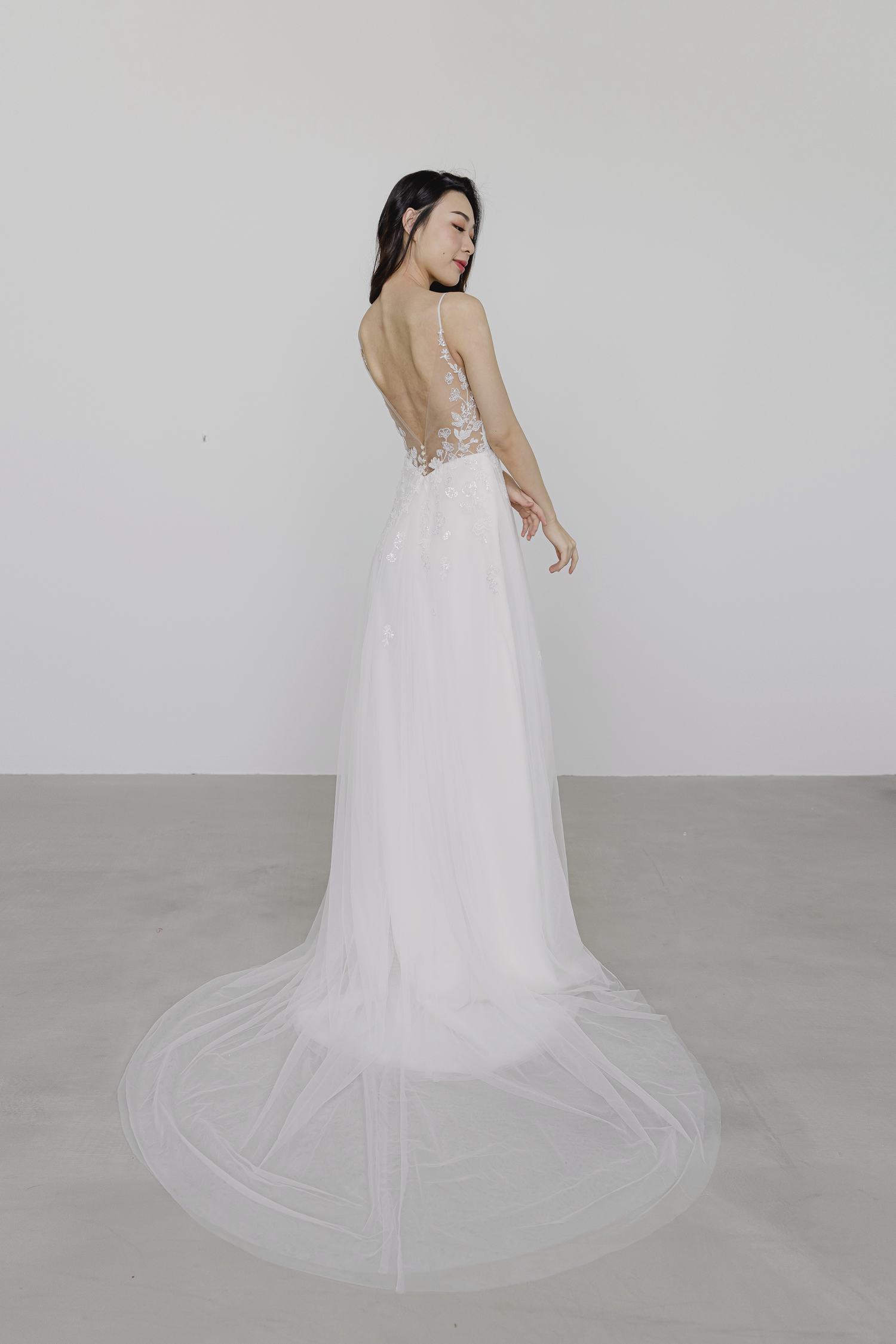 Lexi wedding gown side view with a flowing A-line skirt