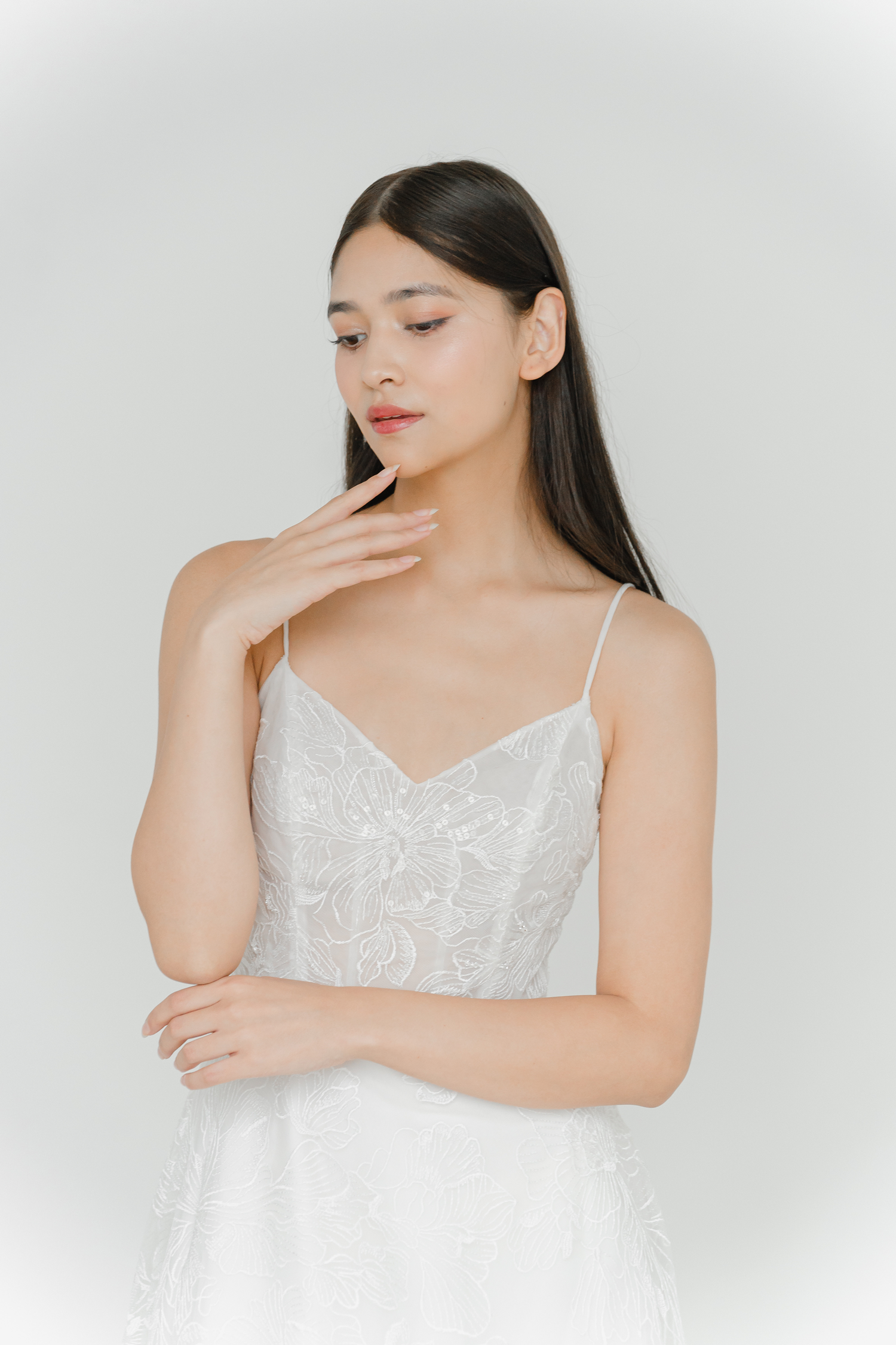Lola wedding dress featuring delicate spaghetti straps and floral lace