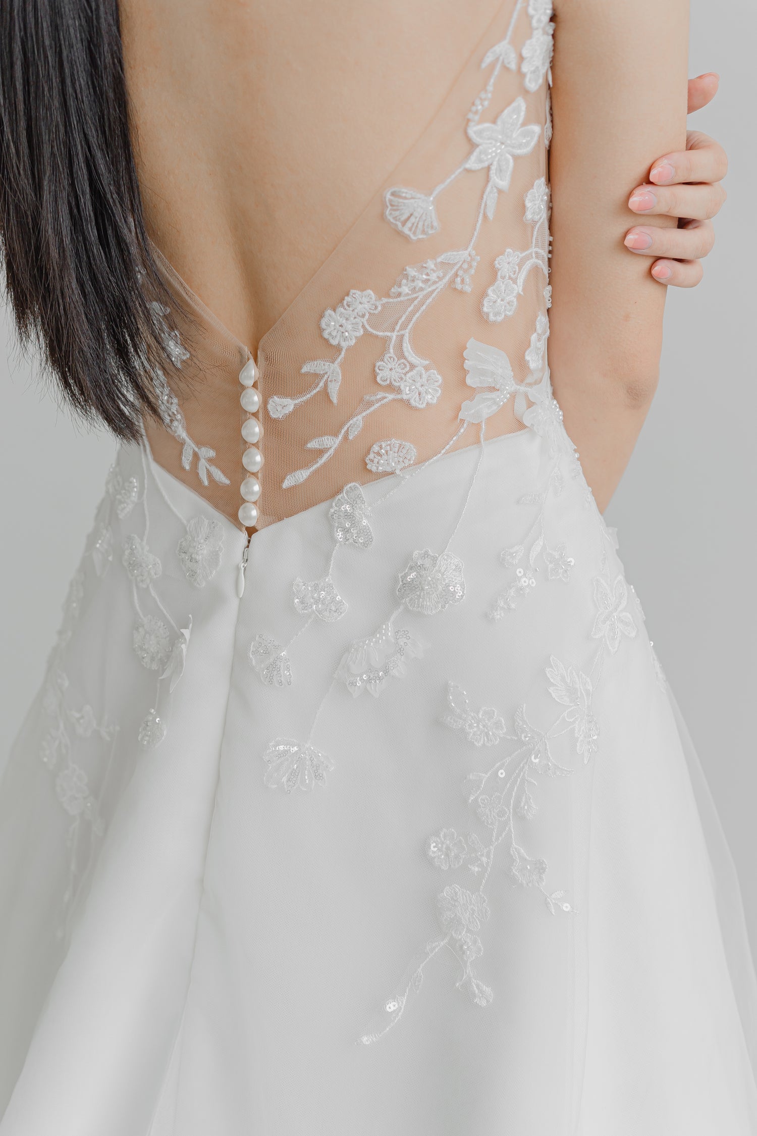 Close-up of Lyra bridal gown showcasing the delicate floral vine lace