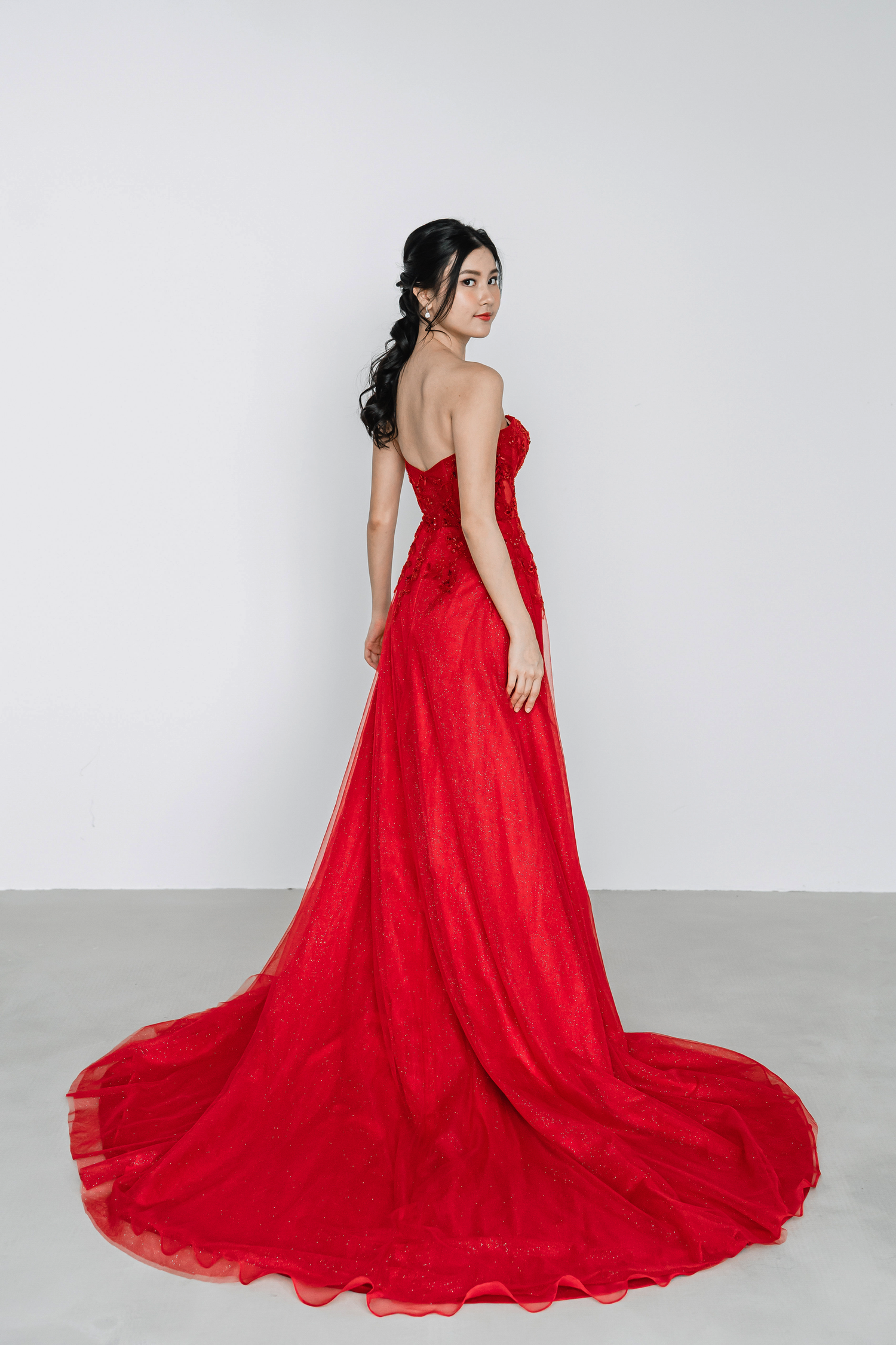 Macy bridal evening gown side view with a flowing glitter tulle skirt