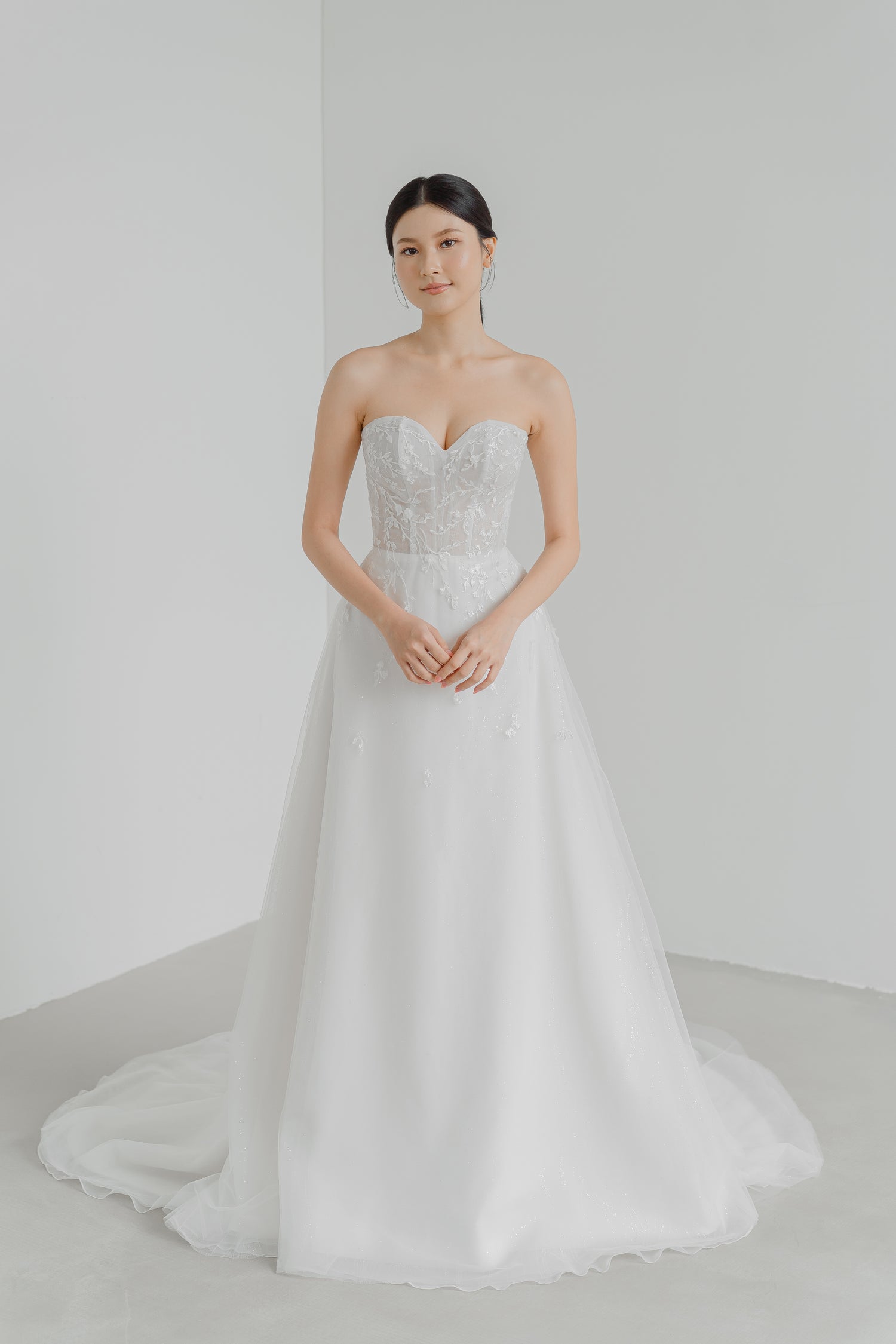 Madelyn wedding dress featuring intricate floral and vine lace over shimmering glitter fabric