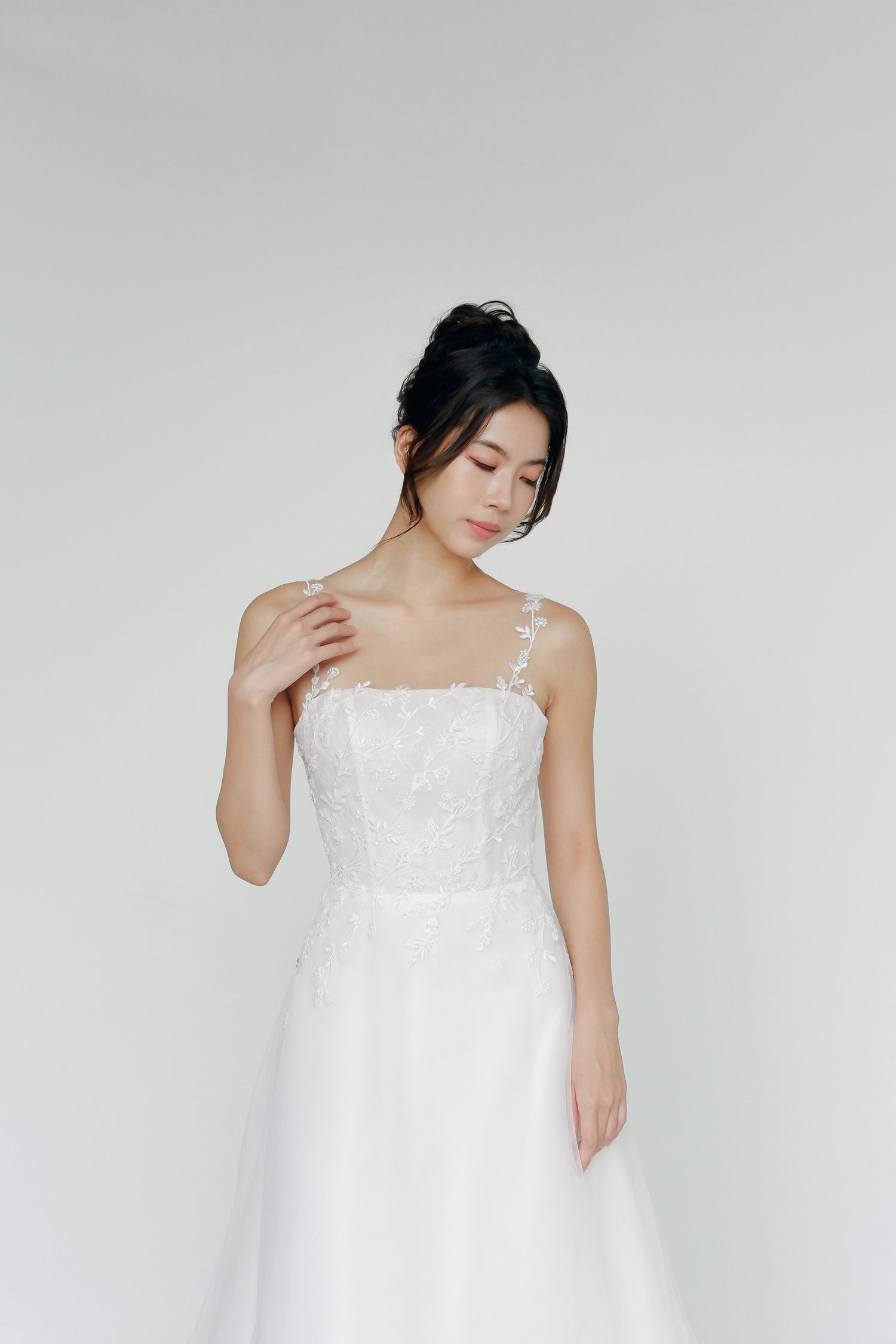 Close-up of Meara bridal gown showcasing the illusion neckline with floral lace straps