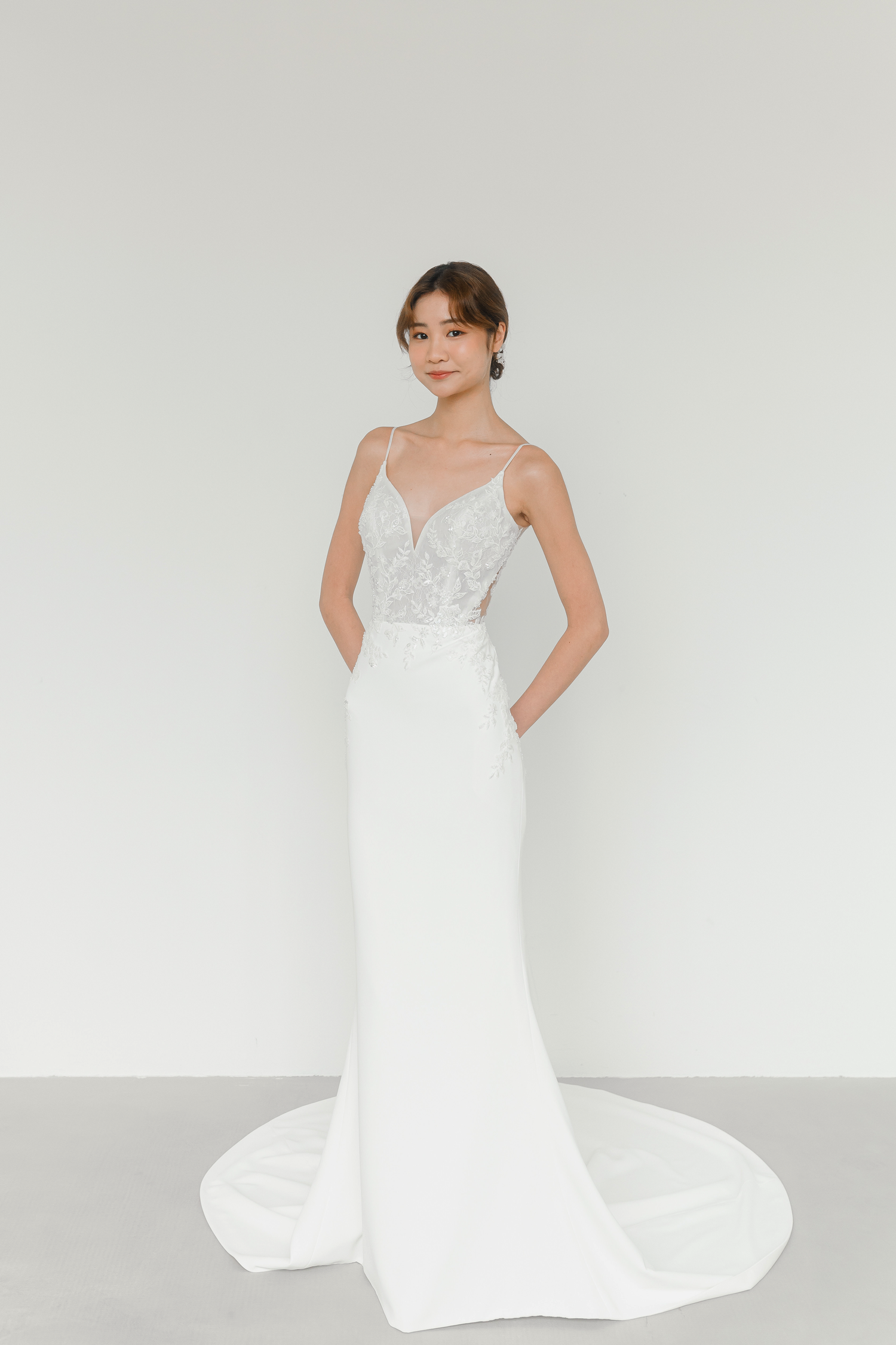 Melanie bridal gown front view with a fitted crepe silhouette and beaded lace bodice