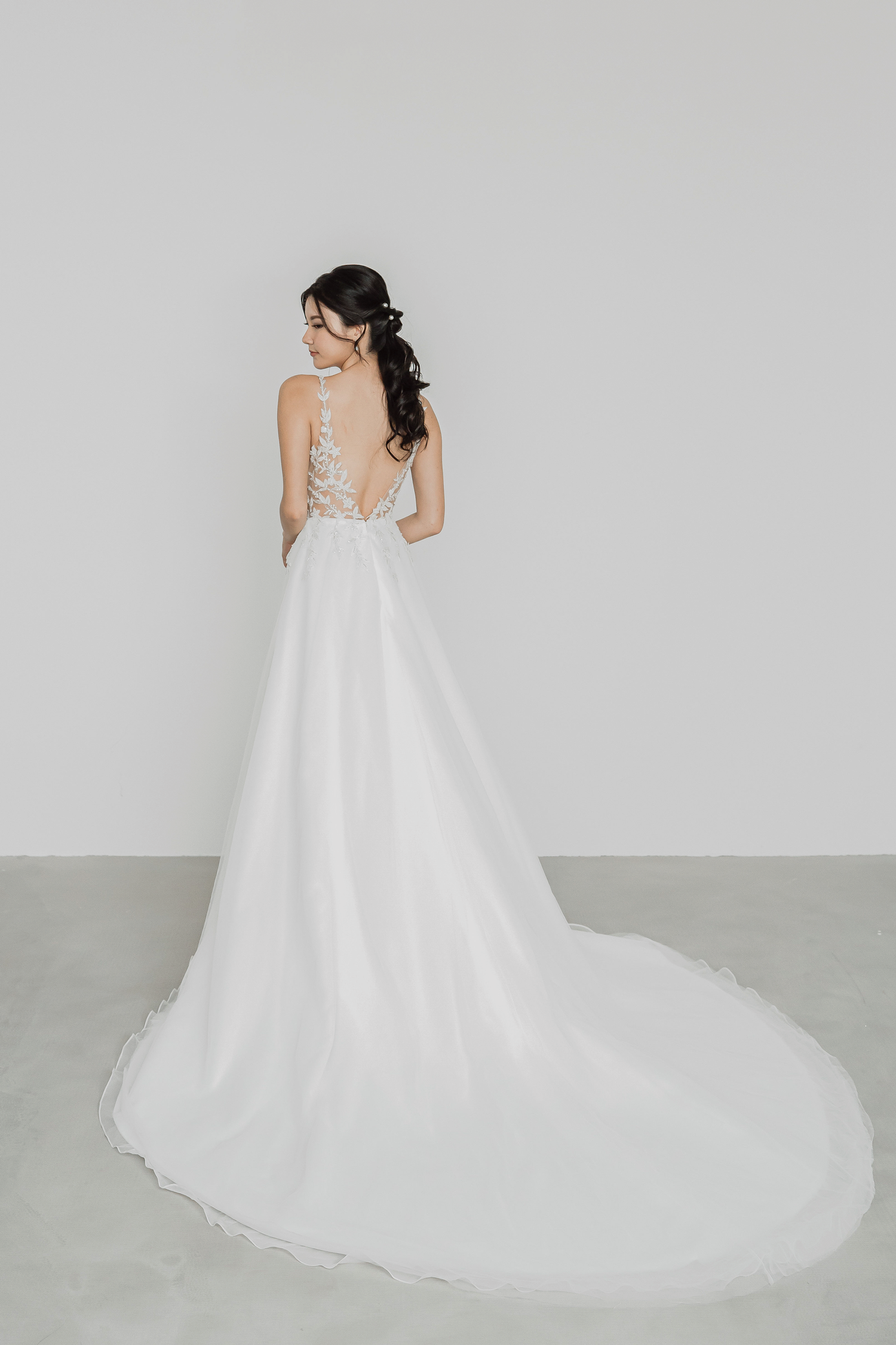 Mindy bridal gown back view with a flowing A-line silhouette
